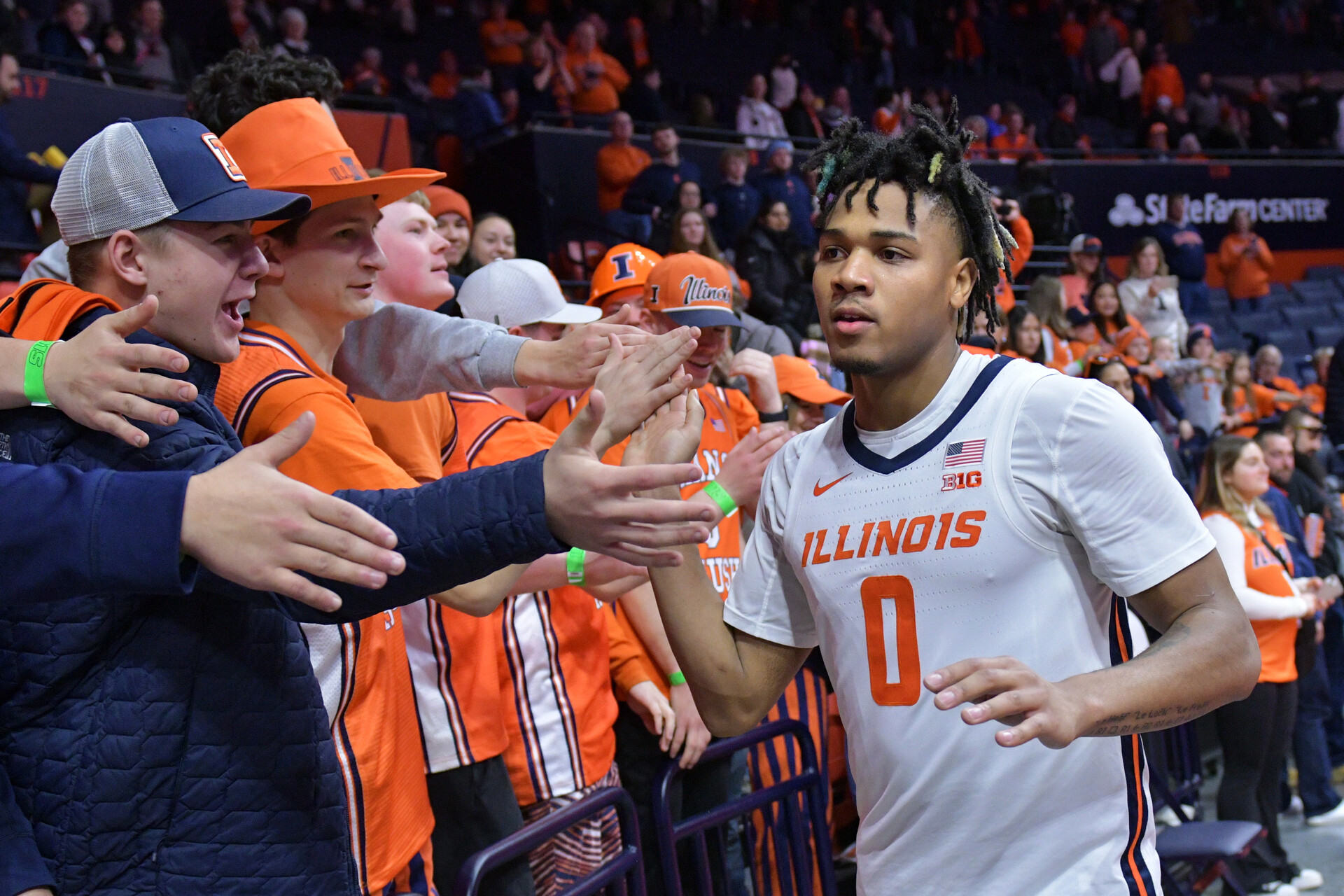 Illinois Fighting Illini guard Terrence Shannon Jr. (0) gets a hand from the fans after a 86-63 game win over the Rutgers Scarlet Knights at State Farm Center.