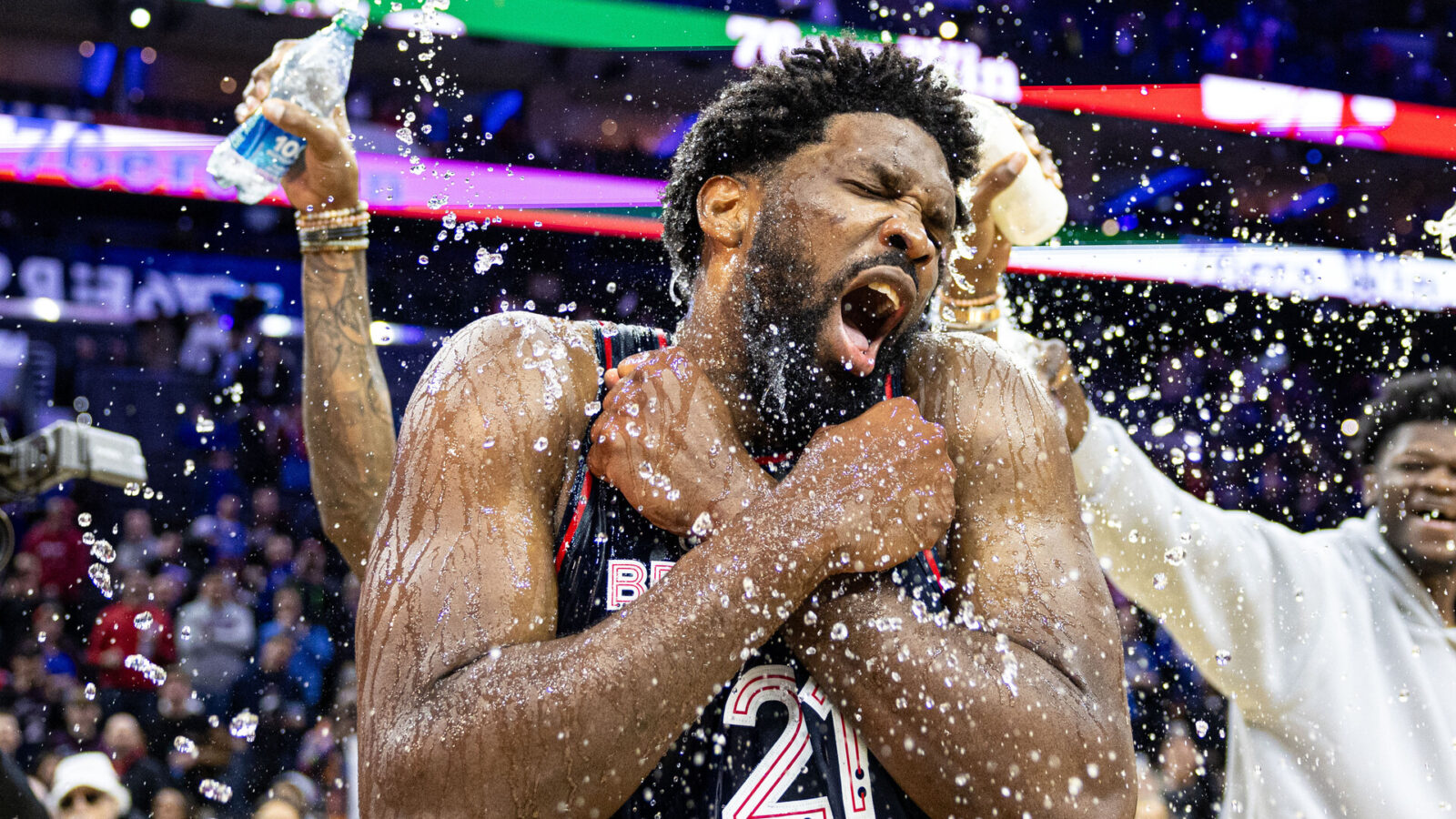 Philadelphia 76ers center Joel Embiid (21) is doused with water by teammates after scoring 70 points in a victory against the San Antonio Spurs at Wells Fargo Center.