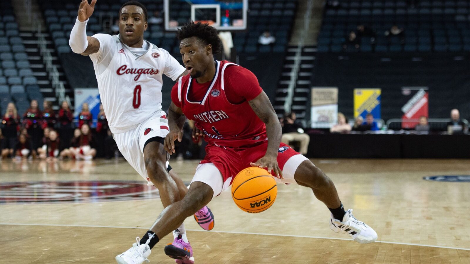 Southern Indiana’s Isaiah Swope (1) dribbles past SIU-Edwardsville’s Damarco Minor (0) during the first round of the Ohio Valley Conference at Ford Center on Wednesday night, March 1, 2023.