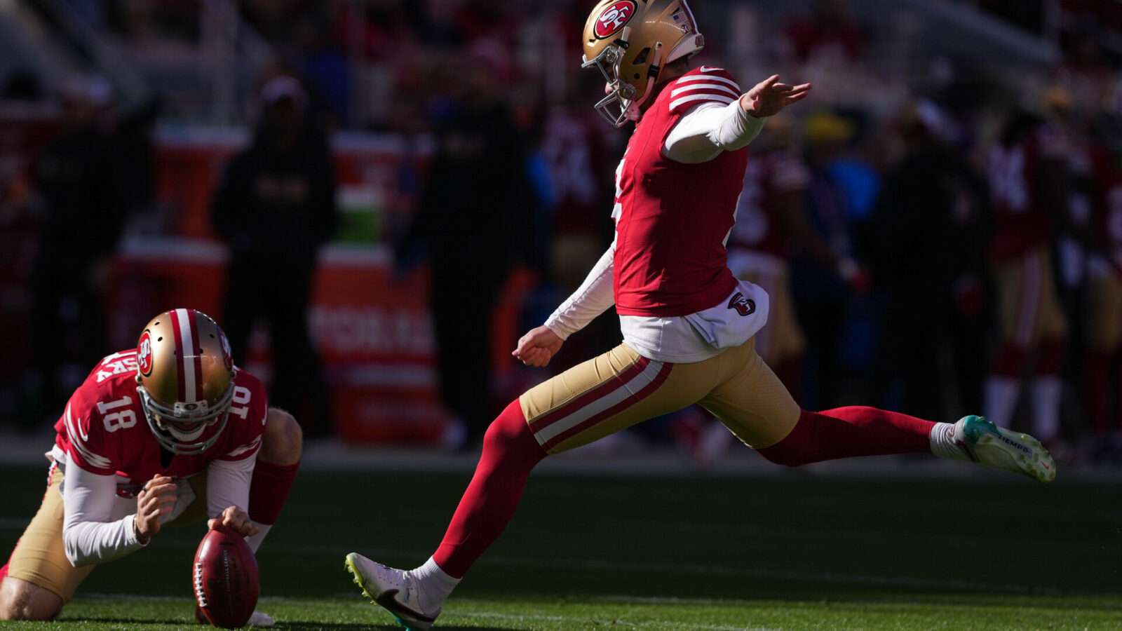 Jan 7, 2024; Santa Clara, California, USA; San Francisco 49ers place kicker Jake Moody (right) kicks an extra point as punter Mitch Wishnowsky (18) holds during the first quarter against the Los Angeles Rams at Levi's Stadium.