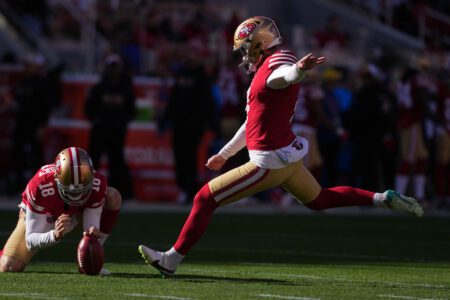 Jan 7, 2024; Santa Clara, California, USA; San Francisco 49ers place kicker Jake Moody (right) kicks an extra point as punter Mitch Wishnowsky (18) holds during the first quarter against the Los Angeles Rams at Levi's Stadium.