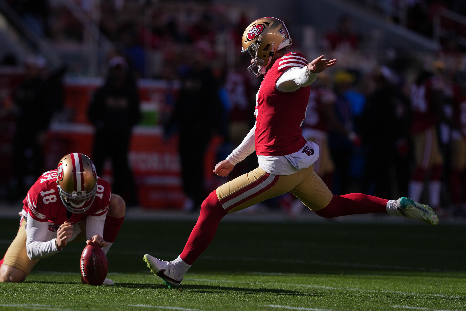 Jan 7, 2024; Santa Clara, California, USA; San Francisco 49ers place kicker Jake Moody (right) kicks an extra point as punter Mitch Wishnowsky (18) holds during the first quarter against the Los Angeles Rams at Levi's Stadium.