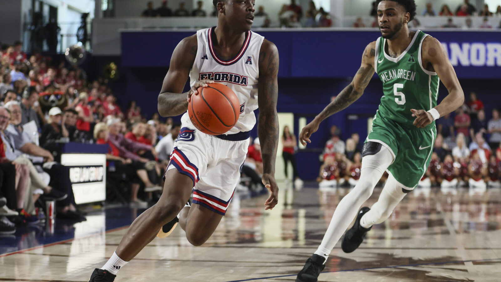 Jan 28, 2024; Boca Raton, Florida, USA; Florida Atlantic Owls guard Johnell Davis (1) drives to the basket past North Texas Mean Green guard Rondel Walker (5) during the second half at Eleanor R. Baldwin Arena