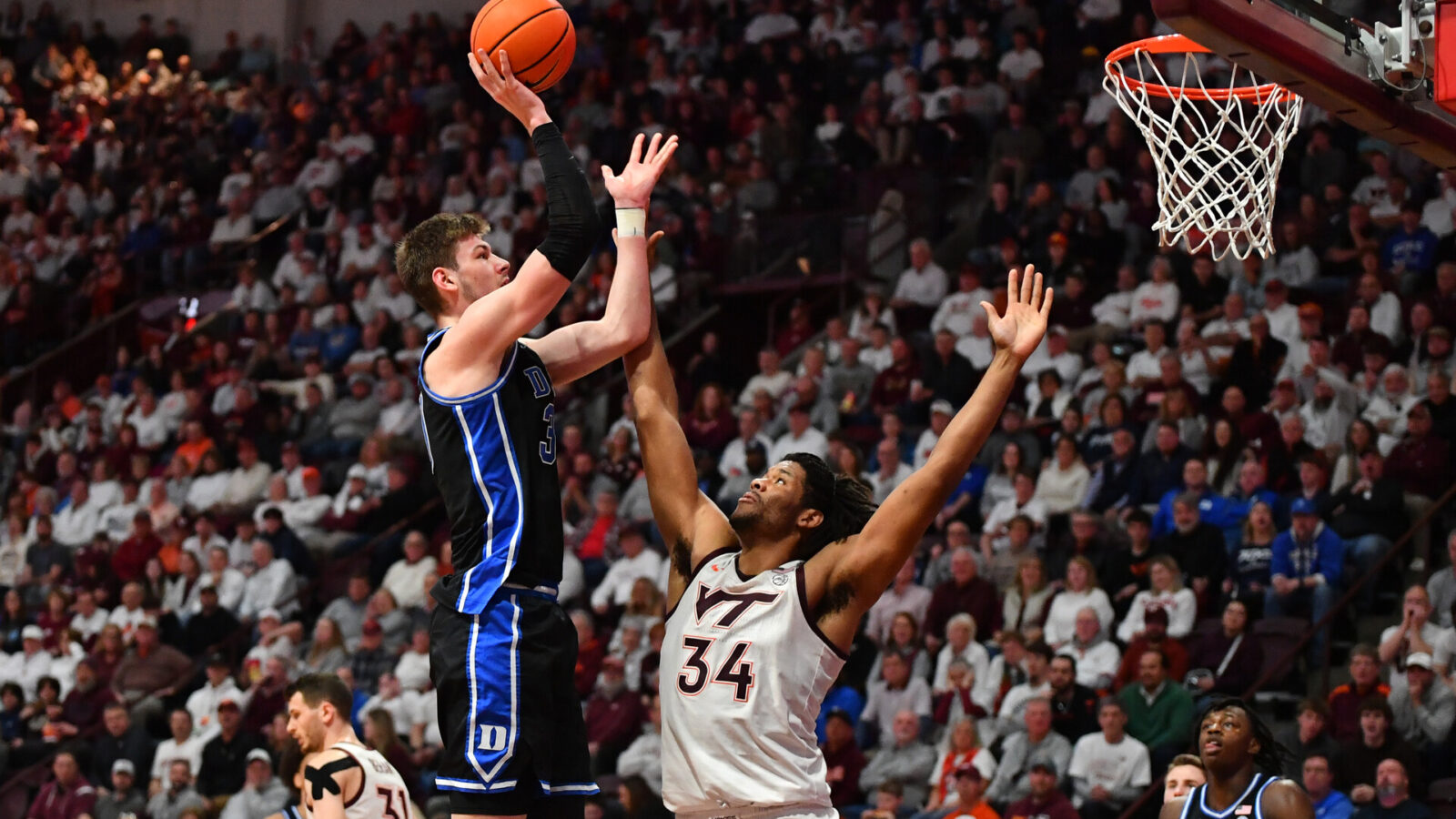 Jan 29, 2024; Blacksburg, Virginia, USA; Duke Blue Devils center Kyle Filipowski (30) shoots while being defended by Virginia Tech Hokies forward Mylyjael Poteat (34) during the second half at Cassell Coliseum.