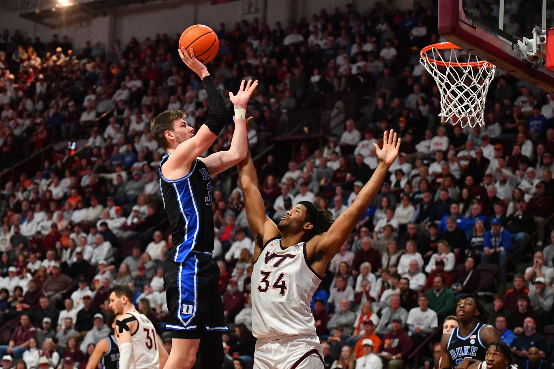 Jan 29, 2024; Blacksburg, Virginia, USA; Duke Blue Devils center Kyle Filipowski (30) shoots while being defended by Virginia Tech Hokies forward Mylyjael Poteat (34) during the second half at Cassell Coliseum.