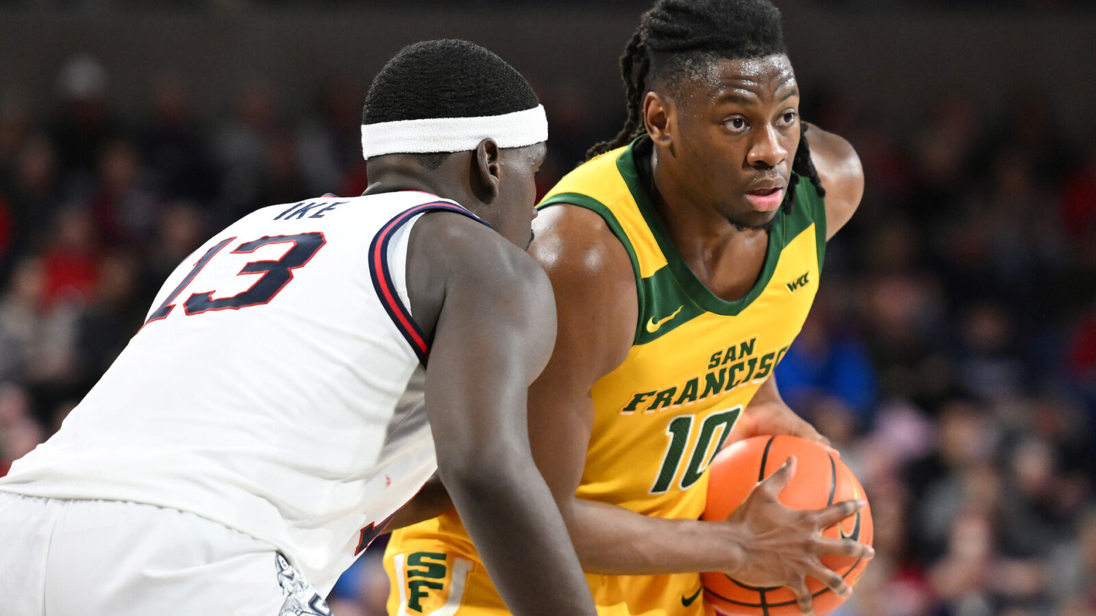 Jan 25, 2024; Spokane, Washington, USA; San Francisco Dons forward Jonathan Mogbo (10) controls the ball against Gonzaga Bulldogs forward Graham Ike (13) in the first half at McCarthey Athletic Center.