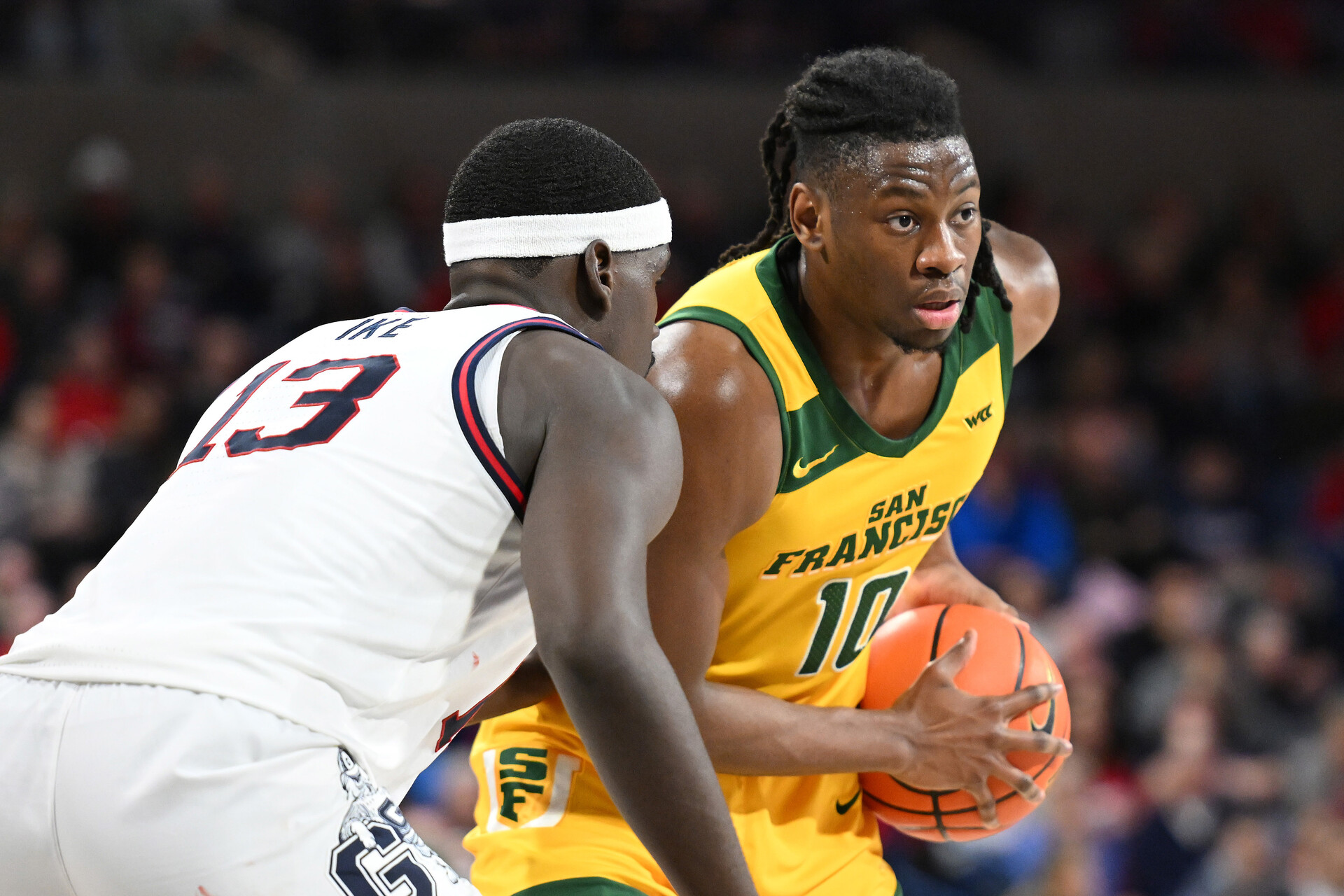 Jan 25, 2024; Spokane, Washington, USA; San Francisco Dons forward Jonathan Mogbo (10) controls the ball against Gonzaga Bulldogs forward Graham Ike (13) in the first half at McCarthey Athletic Center.