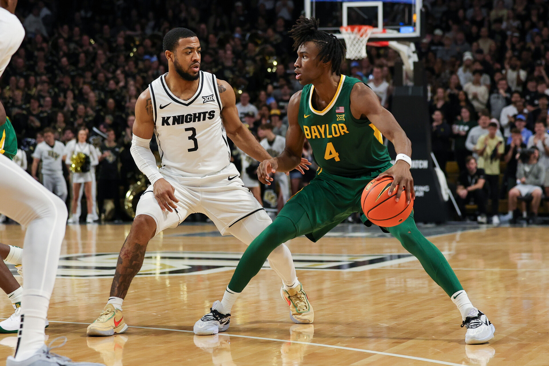 Jan 31, 2024; Orlando, Florida, USA; UCF Knights guard Darius Johnson (3) defends Baylor Bears guard Ja'Kobe Walter (4) during the first half at Addition Financial Arena.
