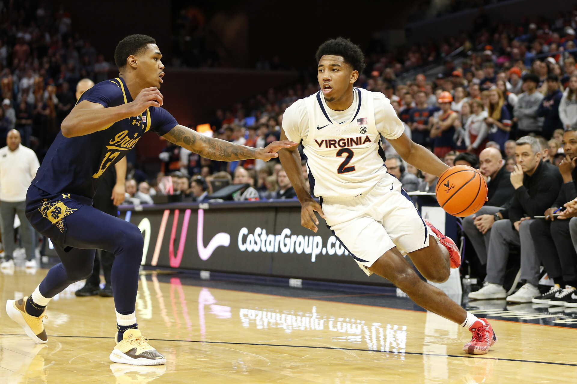 Jan 31, 2024; Charlottesville, Virginia, USA; Virginia Cavaliers guard Reece Beekman (2) dribbles the ball as Notre Dame Fighting Irish forward Tae Davis (13) defends during the second half at John Paul Jones Arena.