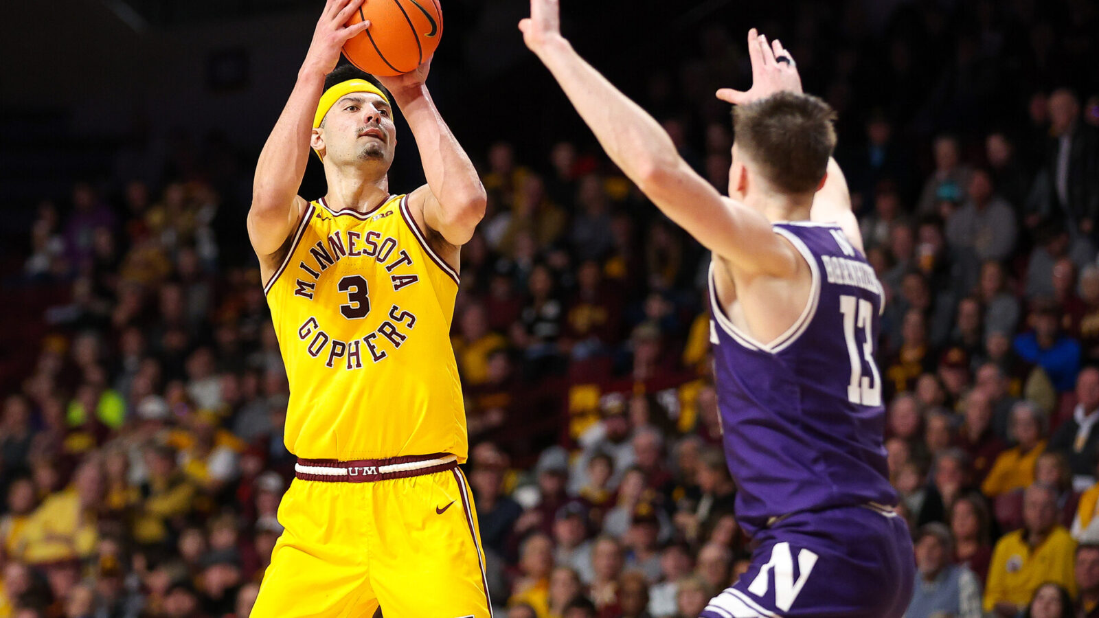 Feb 3, 2024; Minneapolis, Minnesota, USA; Minnesota Golden Gophers forward Dawson Garcia (3) shoots as Northwestern Wildcats guard Brooks Barnhizer (13) defends during the first half at Williams Arena.