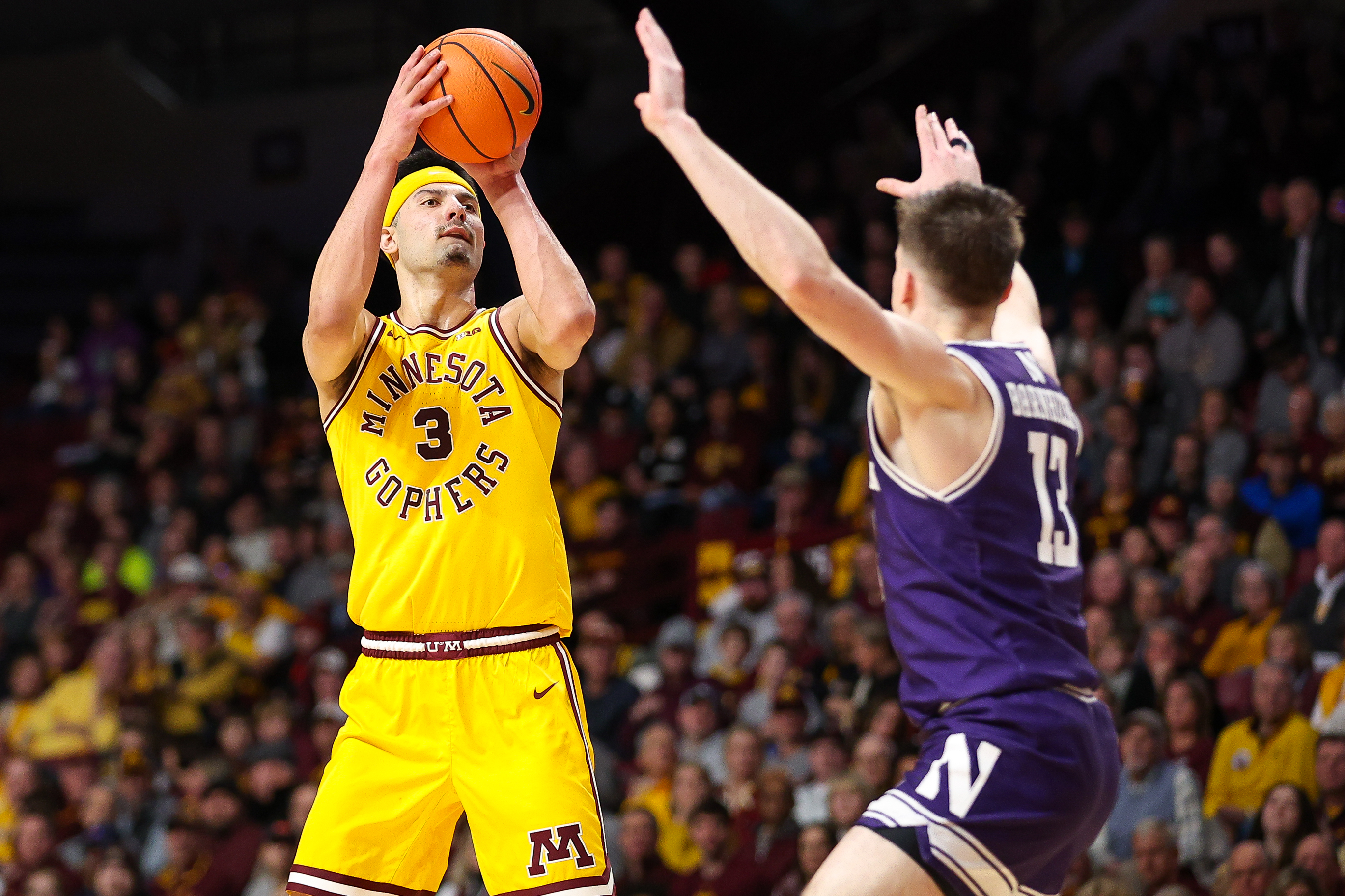 Feb 3, 2024; Minneapolis, Minnesota, USA; Minnesota Golden Gophers forward Dawson Garcia (3) shoots as Northwestern Wildcats guard Brooks Barnhizer (13) defends during the first half at Williams Arena.