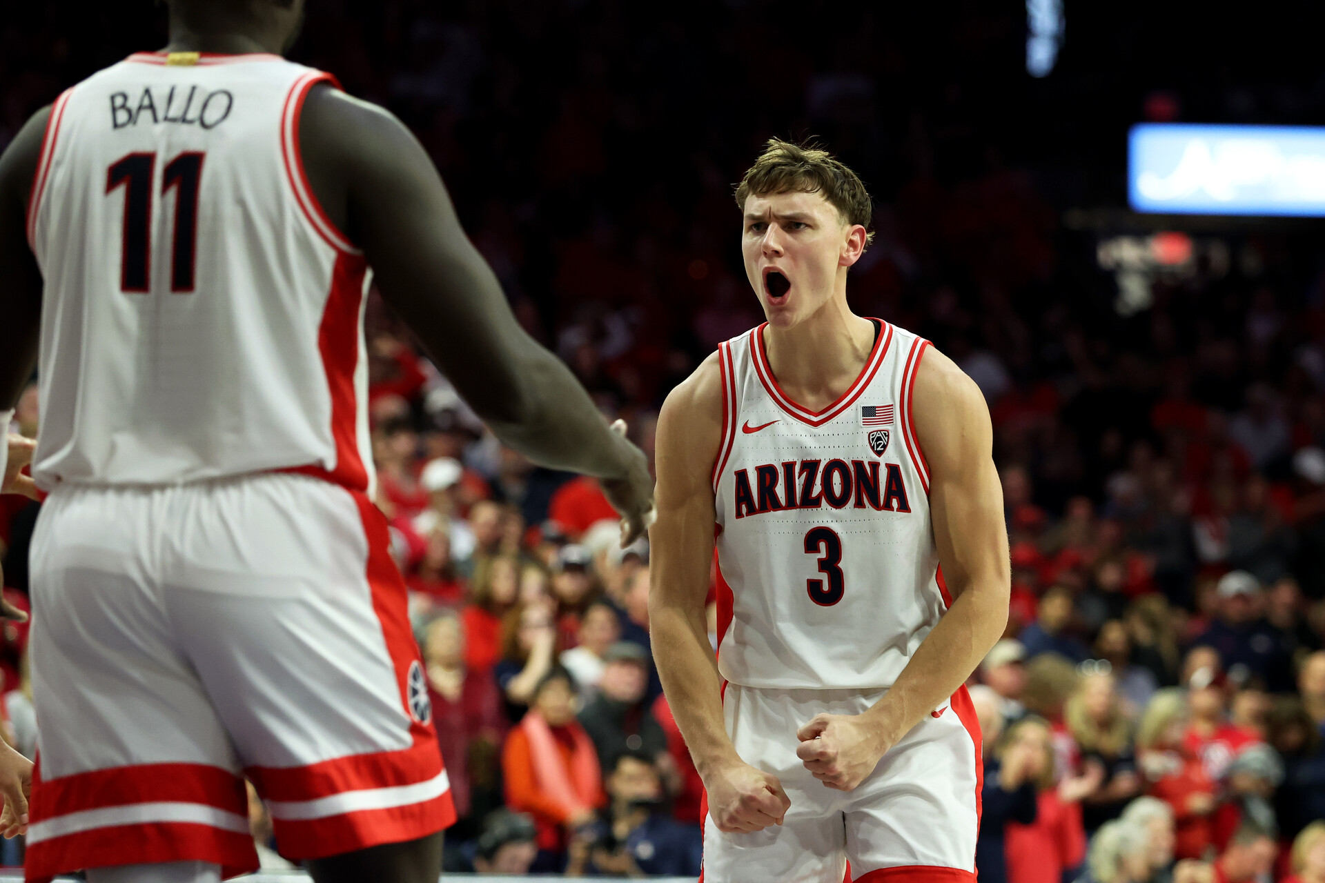 Feb 4, 2024; Tucson, Arizona, USA; Arizona Wildcats guard Pelle Larsson (3) celebrates with Arizona Wildcats center Oumar Ballo (11) after he scored a basket agaisnt the Stanford Cardinal during the second half at McKale Center.