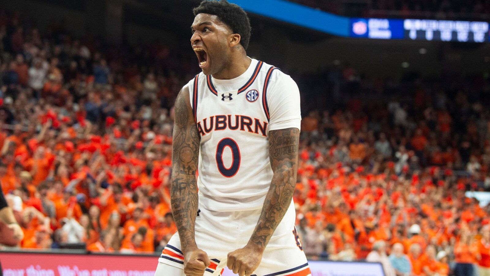 Auburn Tigers guard K.D. Johnson (0) reacts to a Johni Broome (4) block as Auburn Tigers take on Alabama Crimson Tide at Neville Arena in Auburn, Ala., on Wednesday, Feb. 7, 2024.