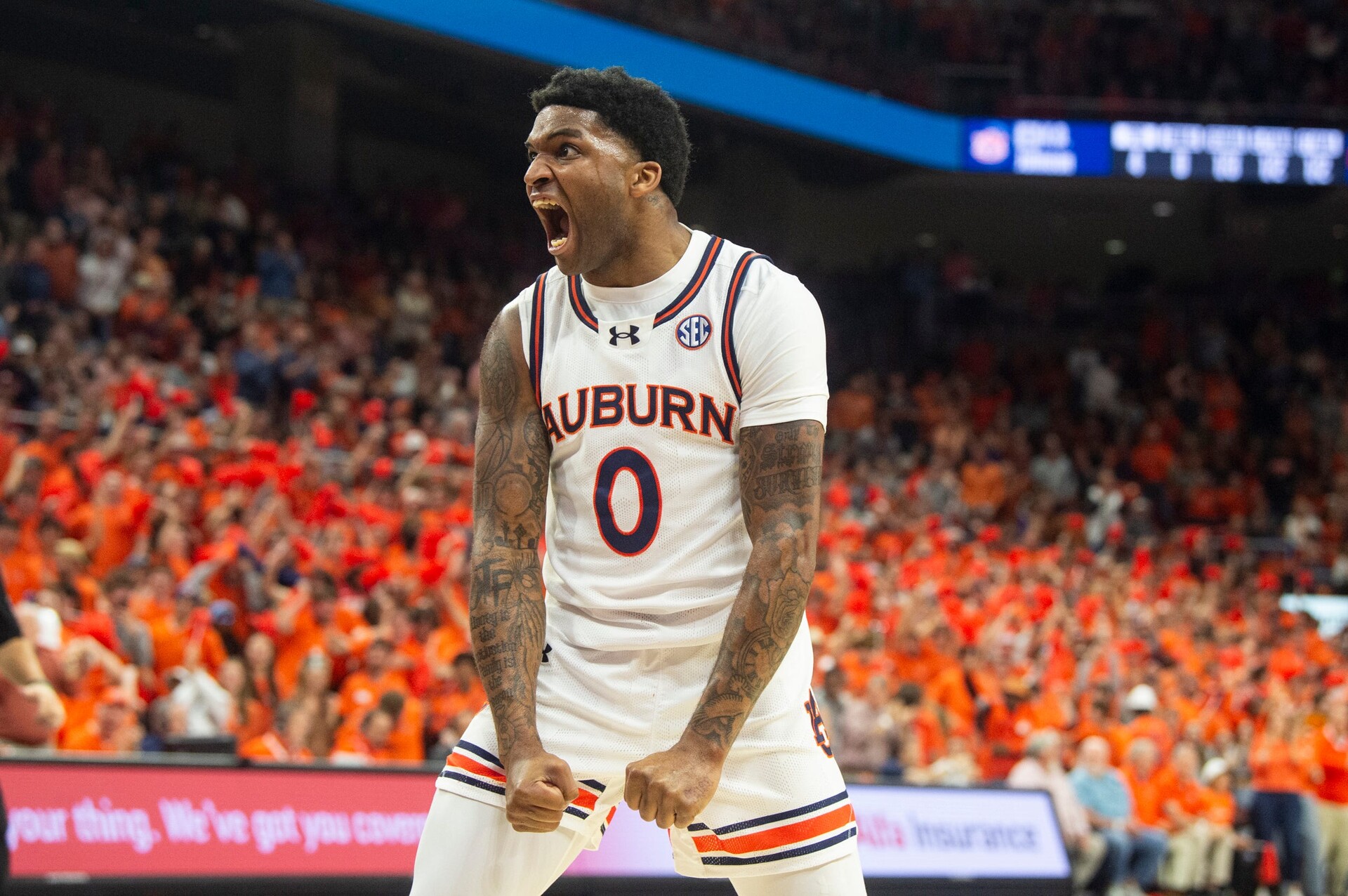 Auburn Tigers guard K.D. Johnson (0) reacts to a Johni Broome (4) block as Auburn Tigers take on Alabama Crimson Tide at Neville Arena in Auburn, Ala., on Wednesday, Feb. 7, 2024.
