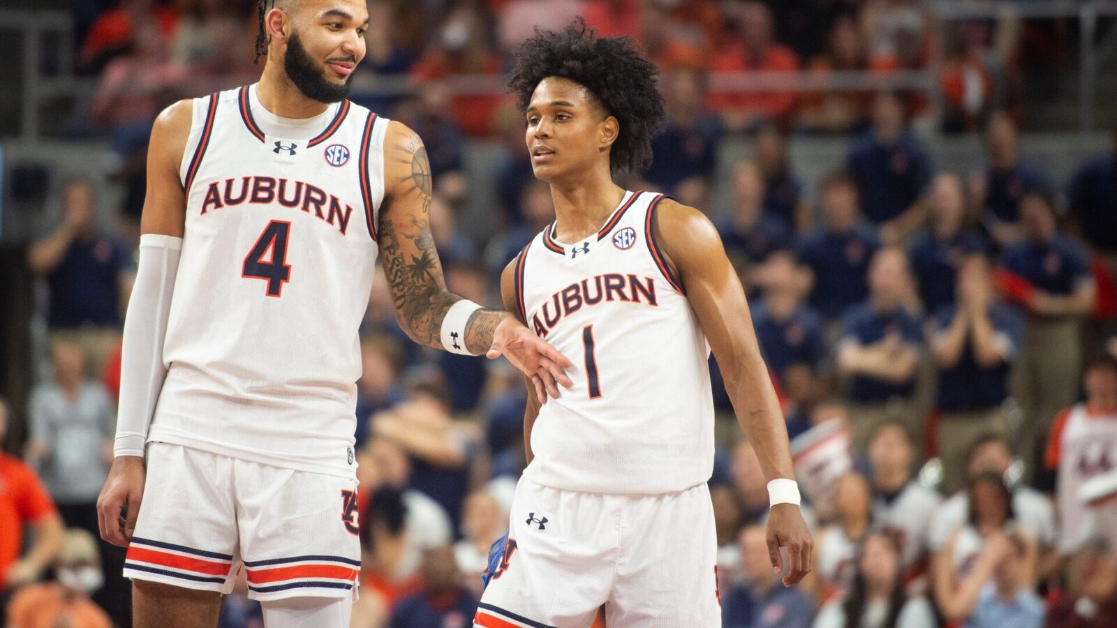 Auburn Tigers forward Johni Broome (4) and guard Aden Holloway (1) talk during free throws as Auburn Tigers take on Alabama Crimson Tide at Neville Arena in Auburn, Ala., on Wednesday, Feb. 7, 2024. Auburn Tigers defeated Alabama Crimson Tide 99-81.
