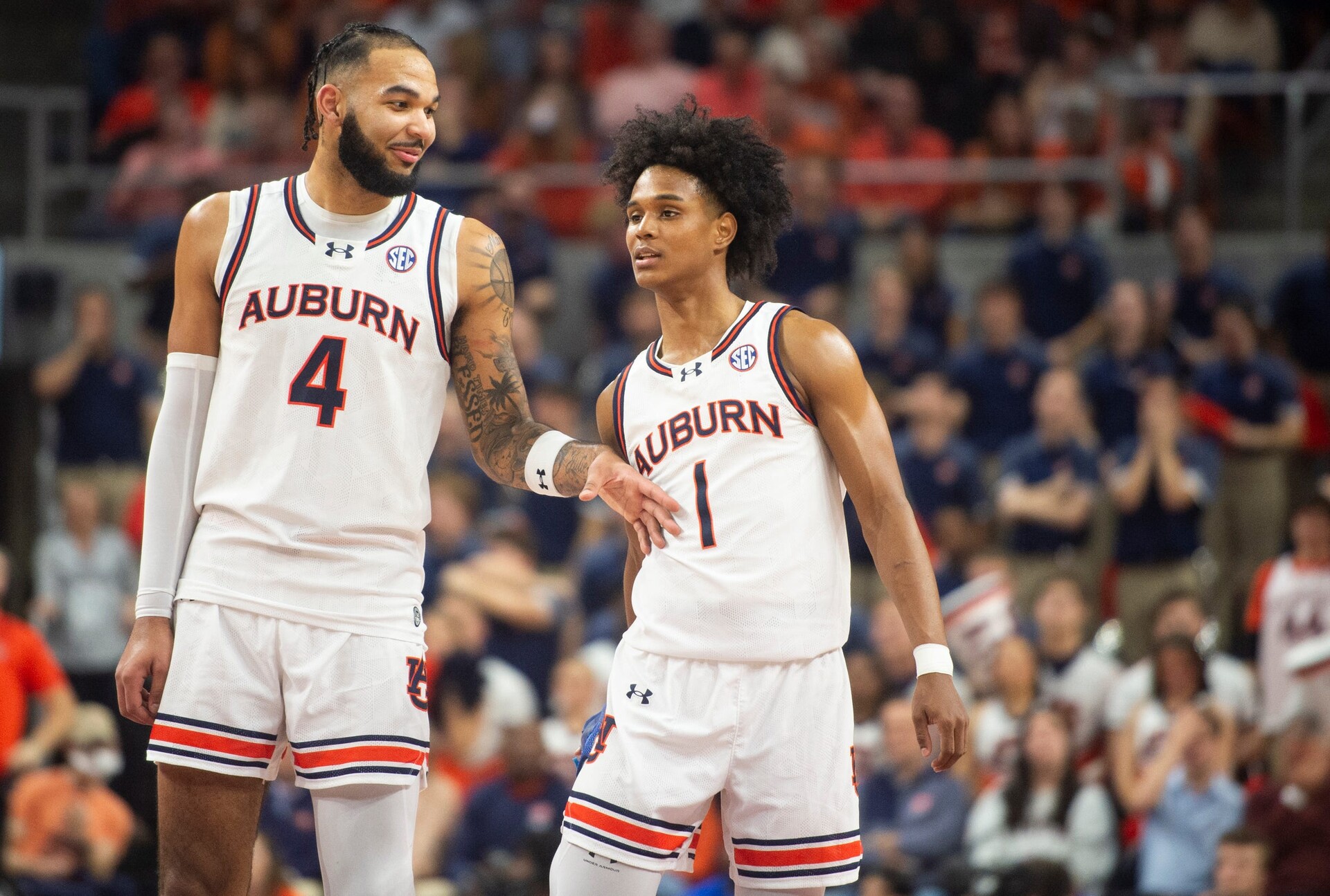 Auburn Tigers forward Johni Broome (4) and guard Aden Holloway (1) talk during free throws as Auburn Tigers take on Alabama Crimson Tide at Neville Arena in Auburn, Ala., on Wednesday, Feb. 7, 2024. Auburn Tigers defeated Alabama Crimson Tide 99-81.