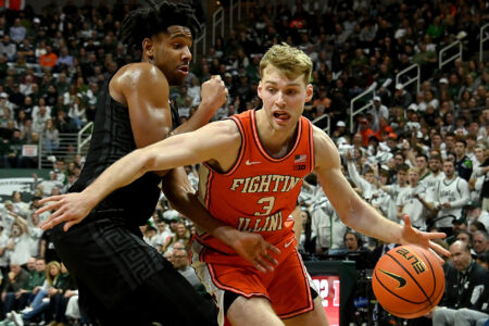 Feb 10, 2024; East Lansing, Michigan, USA; Illinois Fighting Illini forward Marcus Domask (3) drives against Michigan State Spartans guard A.J. Hoggard (11) during the first half at Jack Breslin Student Events Center.