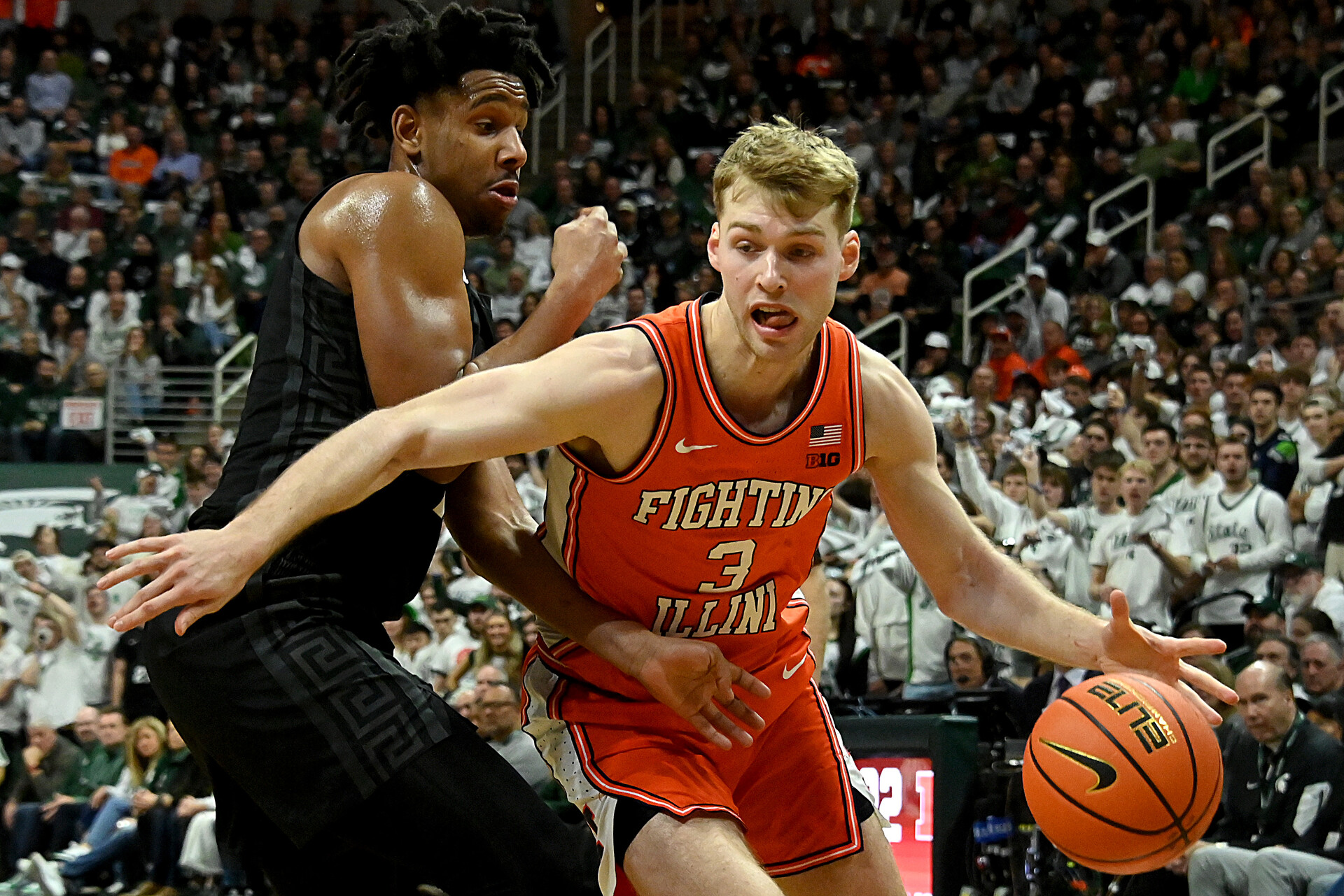 Feb 10, 2024; East Lansing, Michigan, USA; Illinois Fighting Illini forward Marcus Domask (3) drives against Michigan State Spartans guard A.J. Hoggard (11) during the first half at Jack Breslin Student Events Center.