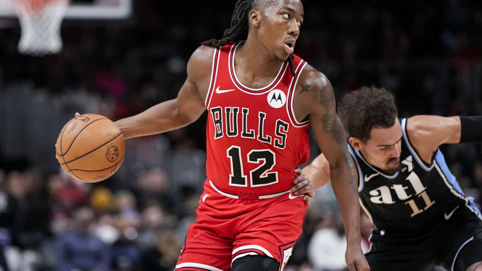 Chicago Bulls guard Ayo Dosunmu (12) is fouled by Atlanta Hawks guard Trae Young (11) during the second half at State Farm Arena.