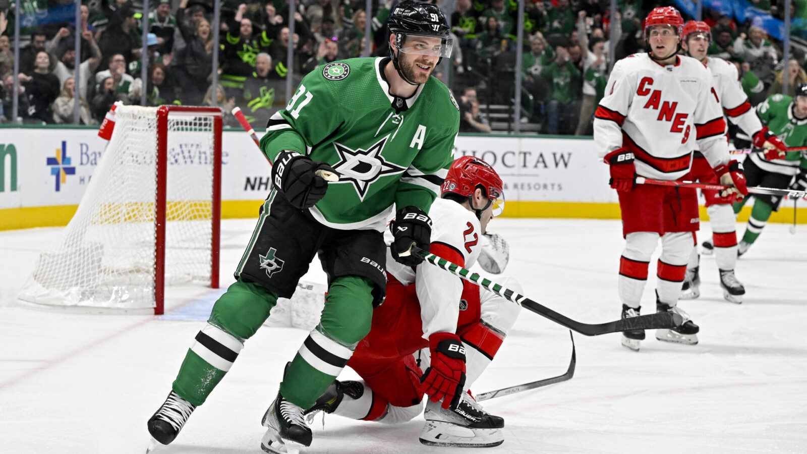 Feb 13, 2024; Dallas, Texas, USA; Dallas Stars center Tyler Seguin (91) smiles after a goal is scored by left wing Mason Marchment (not pictured) against the Carolina Hurricanes during the second period at the American Airlines Center.