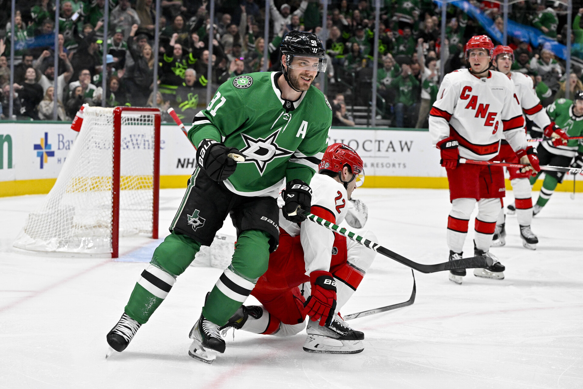 Feb 13, 2024; Dallas, Texas, USA; Dallas Stars center Tyler Seguin (91) smiles after a goal is scored by left wing Mason Marchment (not pictured) against the Carolina Hurricanes during the second period at the American Airlines Center.