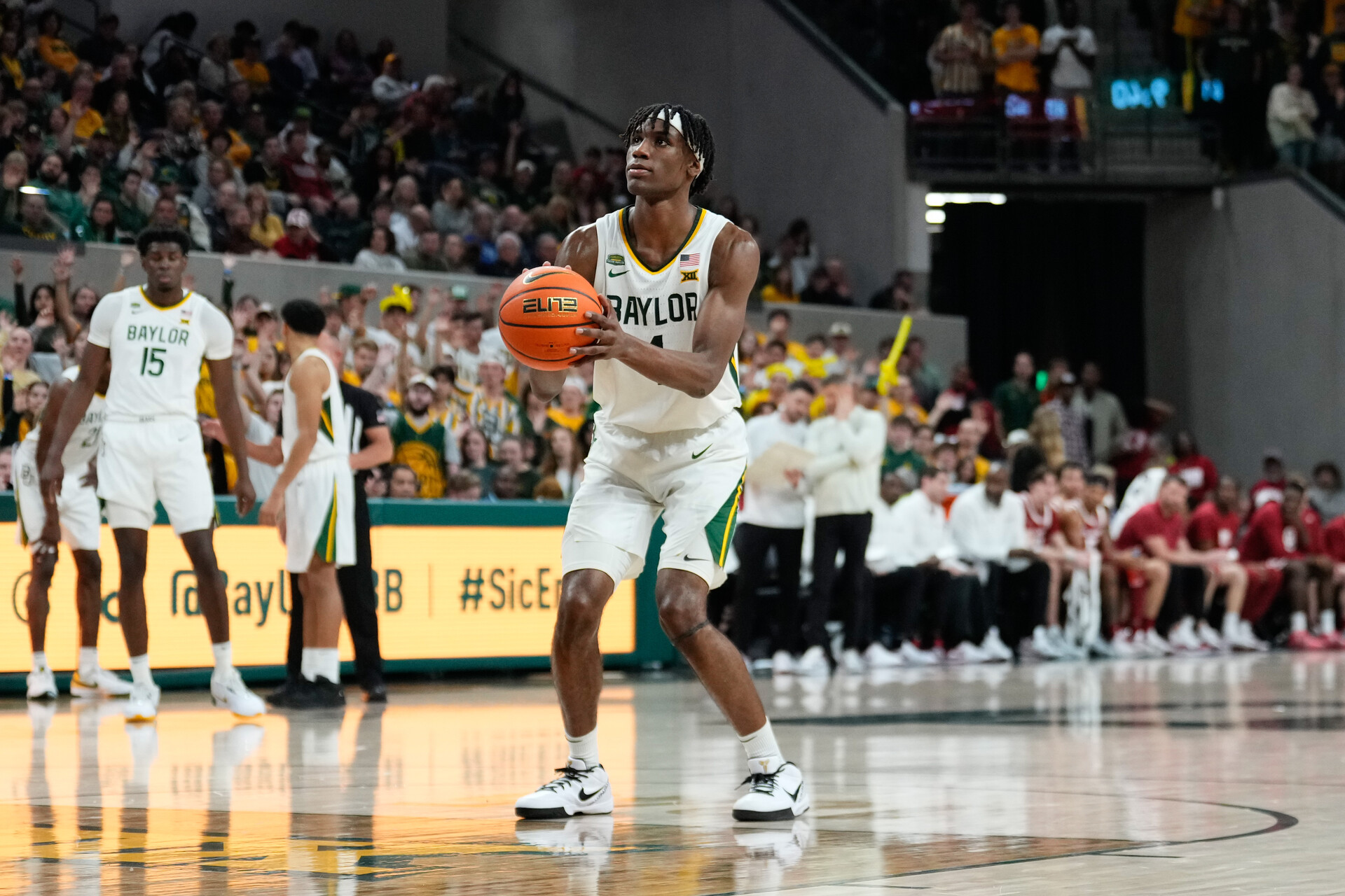 Feb 13, 2024; Waco, Texas, USA; Baylor Bears guard Ja'Kobe Walter (4) shoots a technical free throw against the Oklahoma Sooners during the second half at Paul and Alejandra Foster Pavilion.