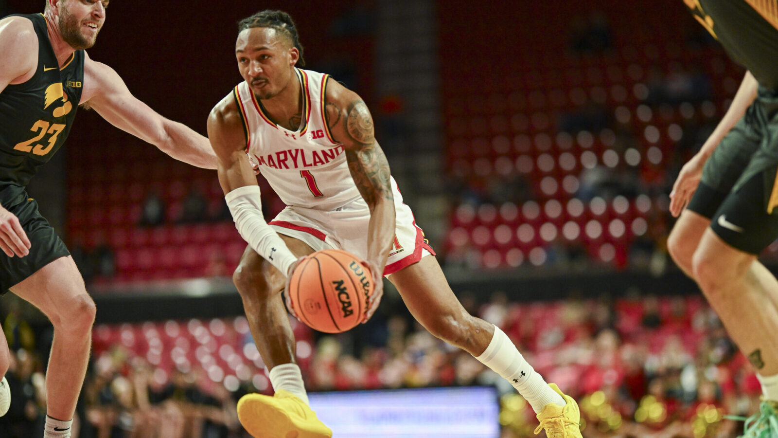 Feb 14, 2024; College Park, Maryland, USA; Maryland Terrapins guard Jahmir Young (1) makes a m move to there basket on Iowa Hawkeyes forward Ben Krikke (23) during the second half at Xfinity Center.