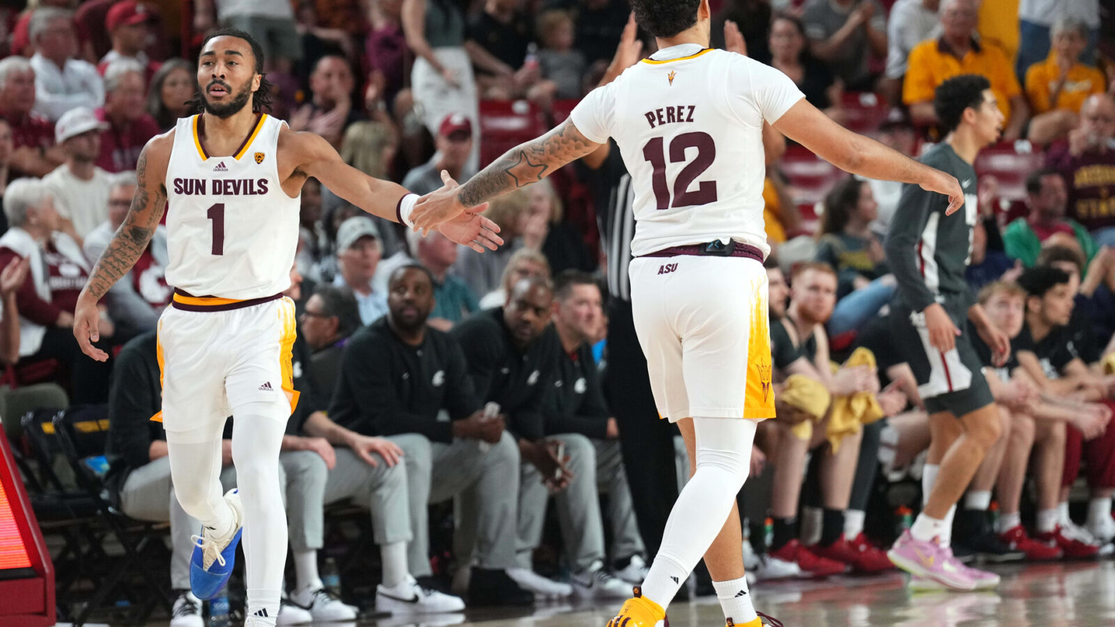 Feb 24, 2024; Tempe, Arizona, USA; Arizona State Sun Devils guard Frankie Collins (1) slaps hands with Arizona State Sun Devils guard Jose Perez (12) during the first half of the game against the Washington State Cougars at Desert Financial Arena.
