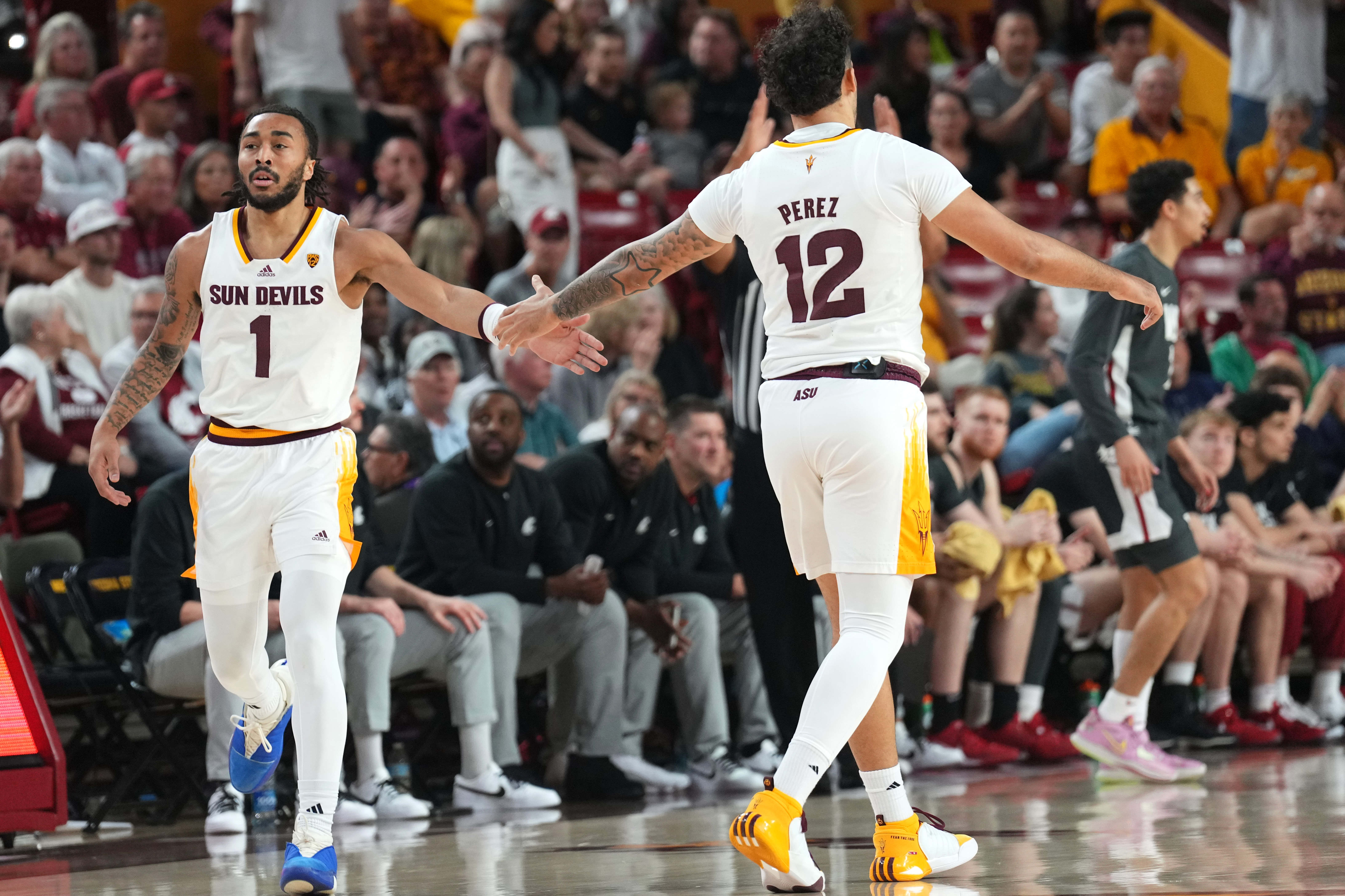 Feb 24, 2024; Tempe, Arizona, USA; Arizona State Sun Devils guard Frankie Collins (1) slaps hands with Arizona State Sun Devils guard Jose Perez (12) during the first half of the game against the Washington State Cougars at Desert Financial Arena.