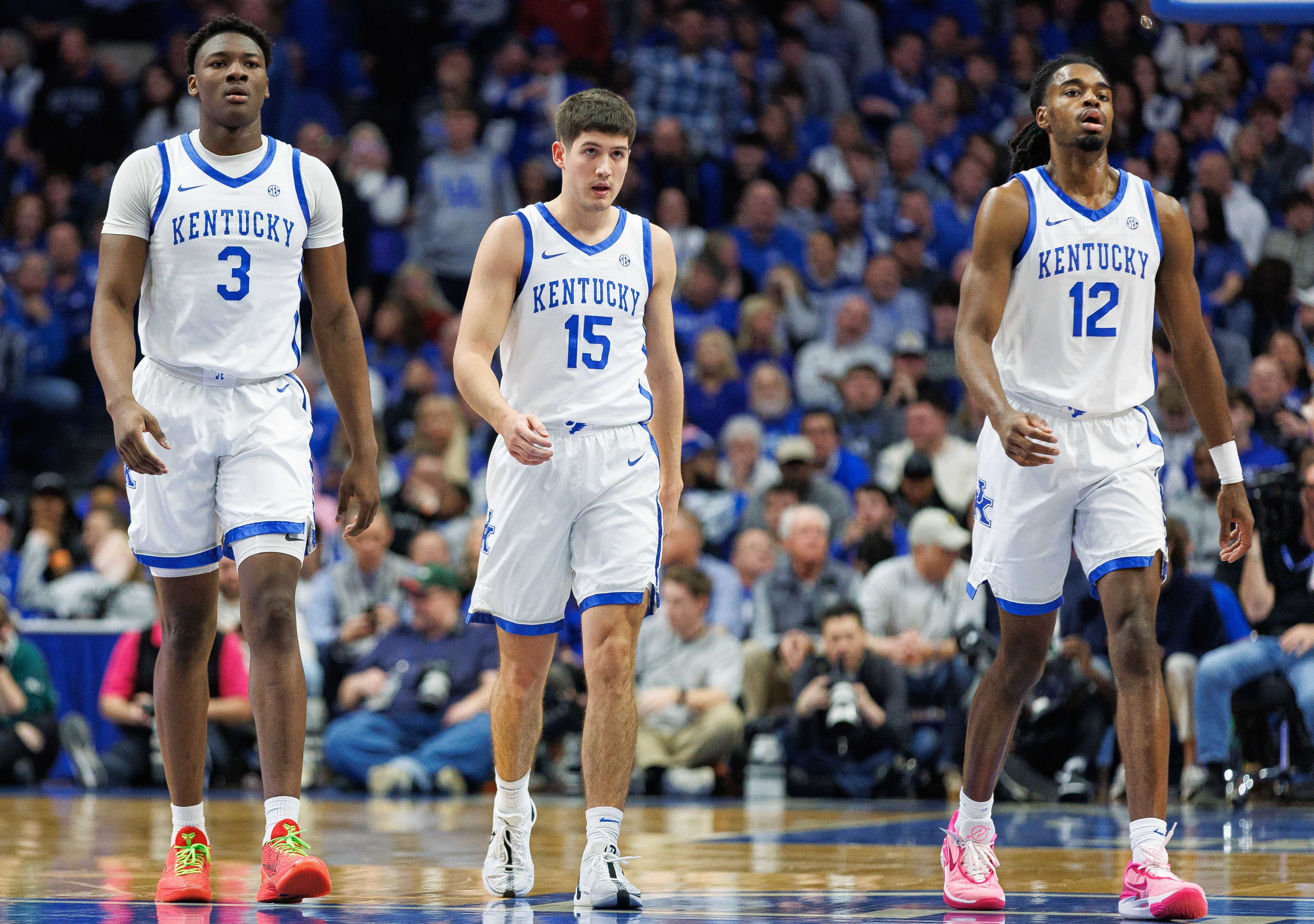 Feb 24, 2024; Lexington, Kentucky, USA; Kentucky Wildcats guards Adou Thiero (3), Reed Sheppard (15) and Antonio Reeves (12) return to the bench during the first half against the Alabama Crimson Tide at Rupp Arena at Central Bank Center.