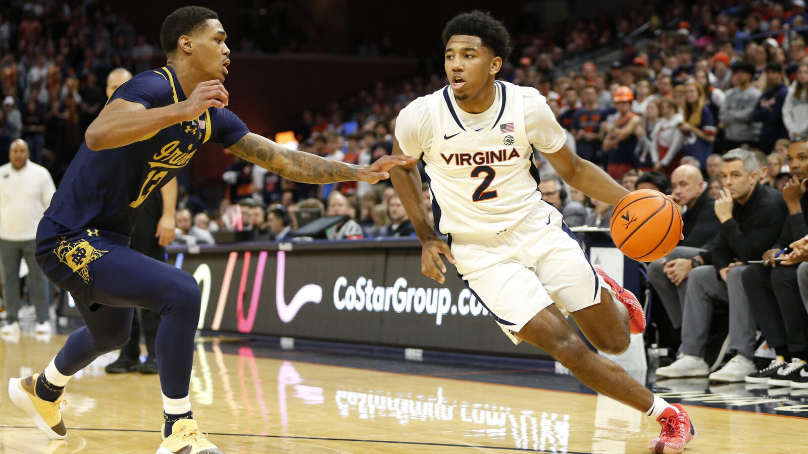 Jan 31, 2024; Charlottesville, Virginia, USA; Virginia Cavaliers guard Reece Beekman (2) dribbles the ball as Notre Dame Fighting Irish forward Tae Davis (13) defends during the second half at John Paul Jones Arena.