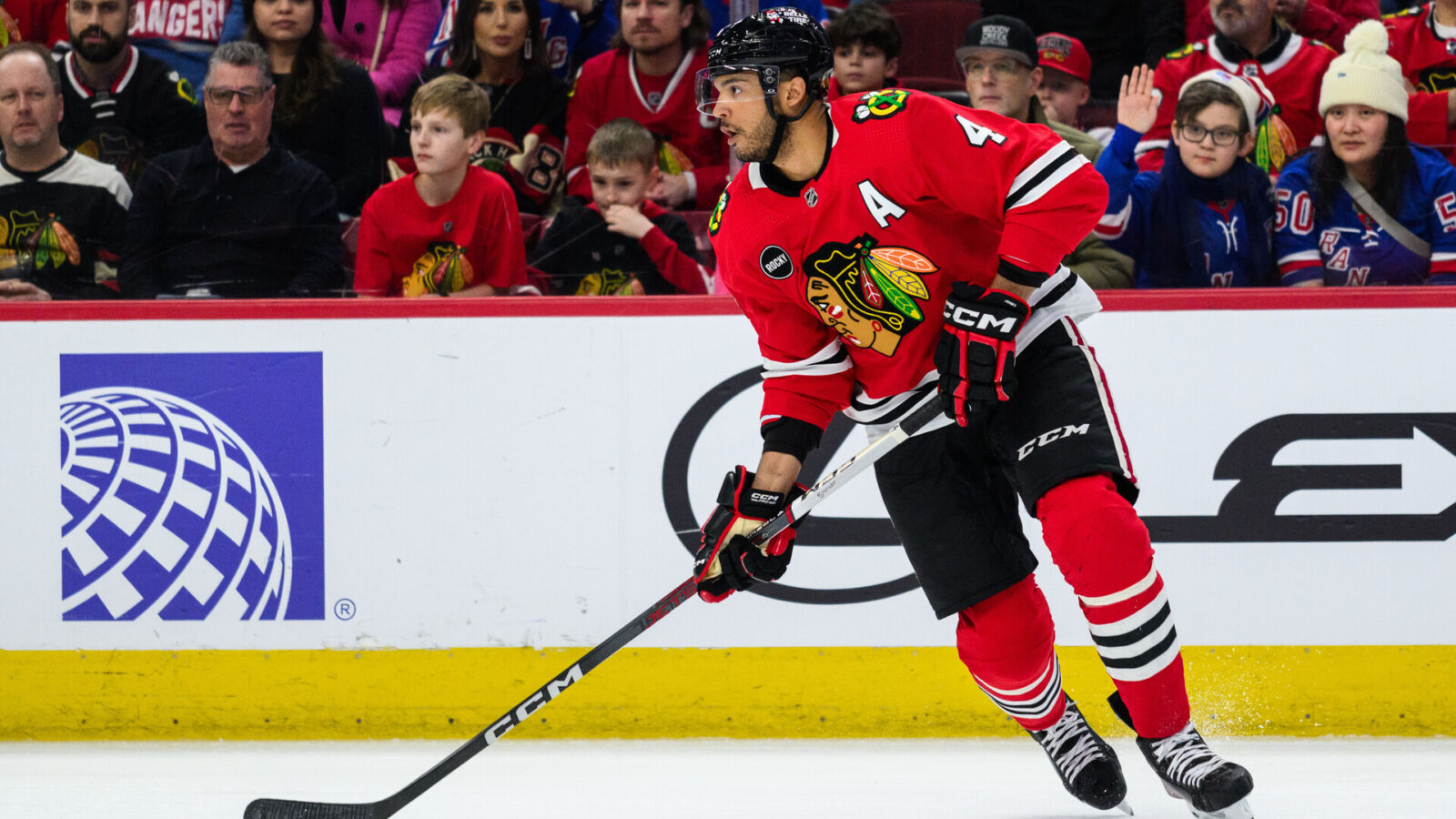 Feb 9, 2024; Chicago, Illinois, USA; Chicago Blackhawks defenseman Seth Jones (4) skates with the puck against the New York Rangers during the first period at the United Center.