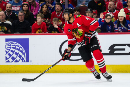 Feb 9, 2024; Chicago, Illinois, USA; Chicago Blackhawks defenseman Seth Jones (4) skates with the puck against the New York Rangers during the first period at the United Center.