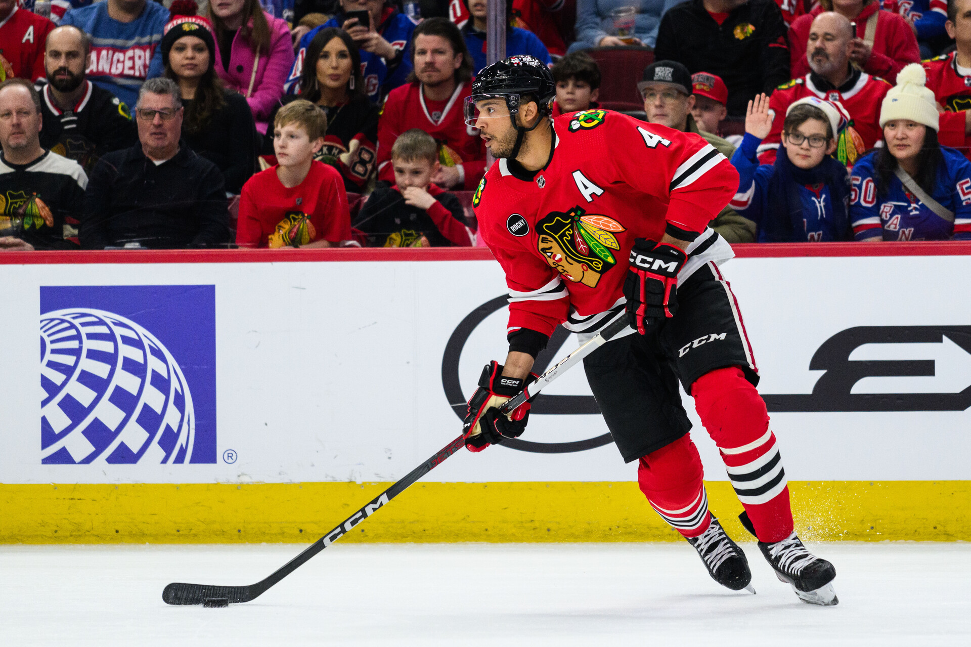 Feb 9, 2024; Chicago, Illinois, USA; Chicago Blackhawks defenseman Seth Jones (4) skates with the puck against the New York Rangers during the first period at the United Center.
