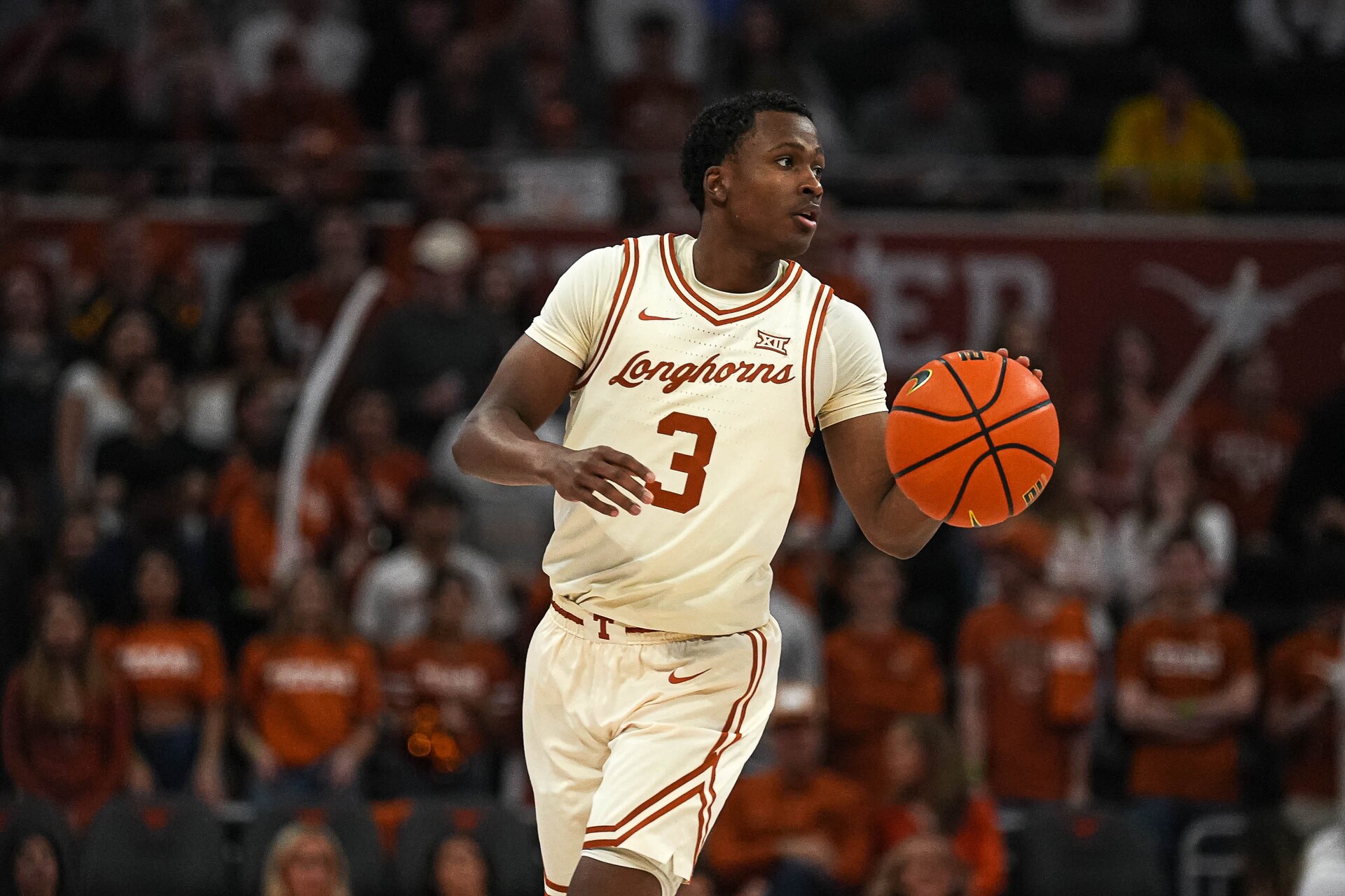 Texas Longhorns guard Max Abmas (3) dribles the ball towards the West Virginia basket during the basketball game at the Moody Center on Saturday, Feb. 10, 2024 in Austin.