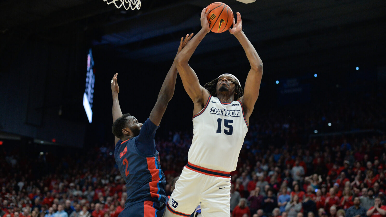Feb 13, 2024; Dayton, Ohio, USA; Dayton Flyers forward DaRon Holmes II (15) shoots the ball against Duquesne forward David Dixon (2) during the game at University of Dayton Arena.
