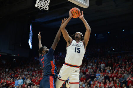 Feb 13, 2024; Dayton, Ohio, USA; Dayton Flyers forward DaRon Holmes II (15) shoots the ball against Duquesne forward David Dixon (2) during the game at University of Dayton Arena.