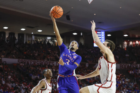 Feb 17, 2024; Norman, Oklahoma, USA; Kansas Jayhawks guard Dajuan Harris Jr. (3) shoots beside Oklahoma Sooners forward Sam Godwin (10) during the first half at Lloyd Noble Center.