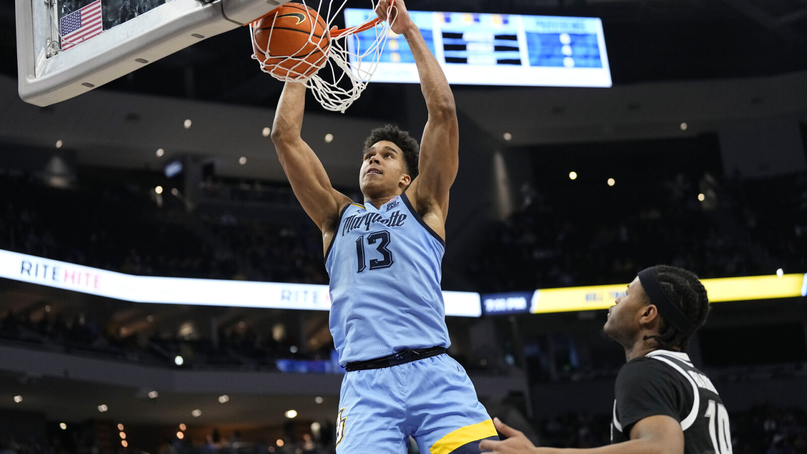 Feb 28, 2024; Milwaukee, Wisconsin, USA; Marquette Golden Eagles forward Oso Ighodaro (13) dunks during the second half against the Providence Friars at Fiserv Forum.