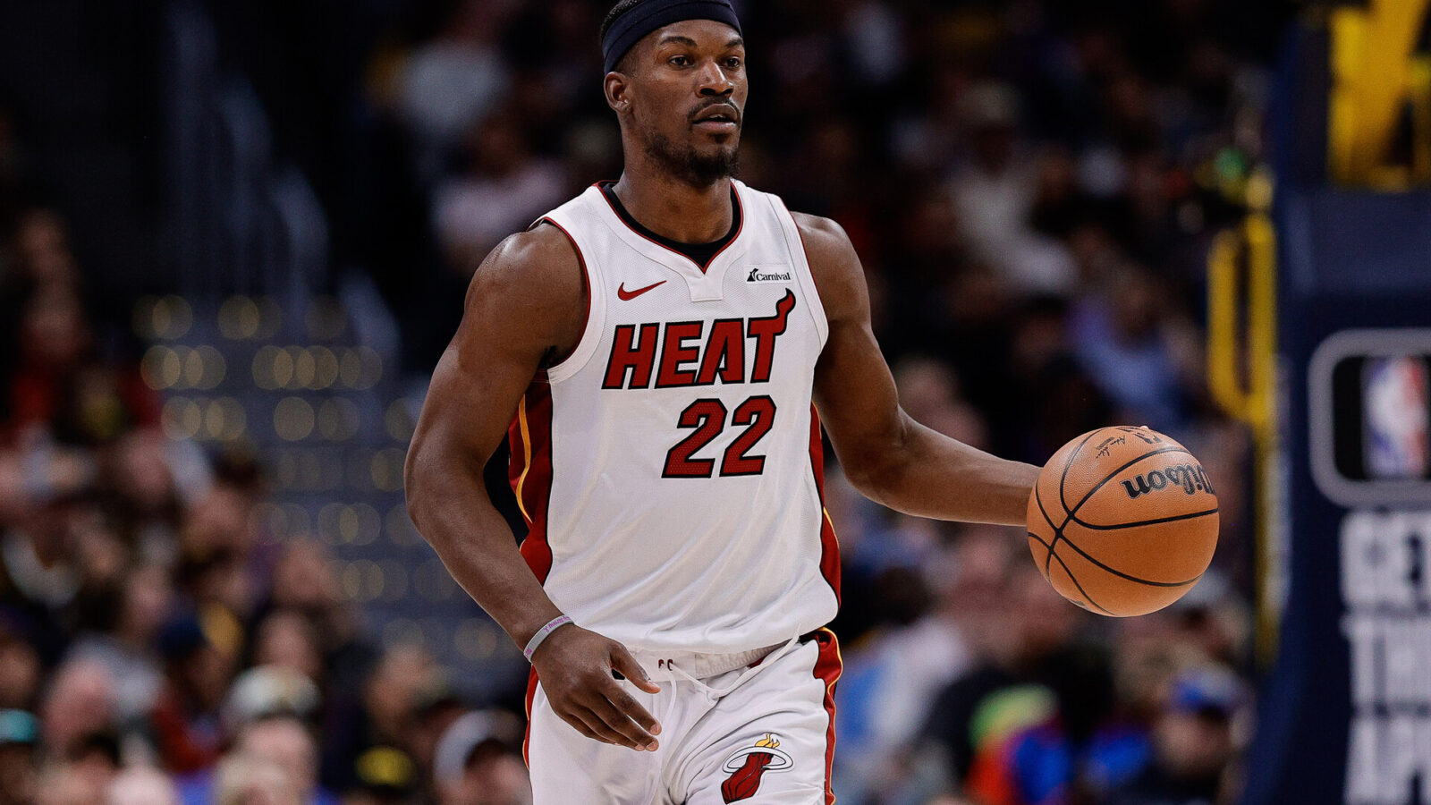 Miami Heat forward Jimmy Butler (22) dribbles the ball up court in the fourth quarter against the Denver Nuggets at Ball Arena.
