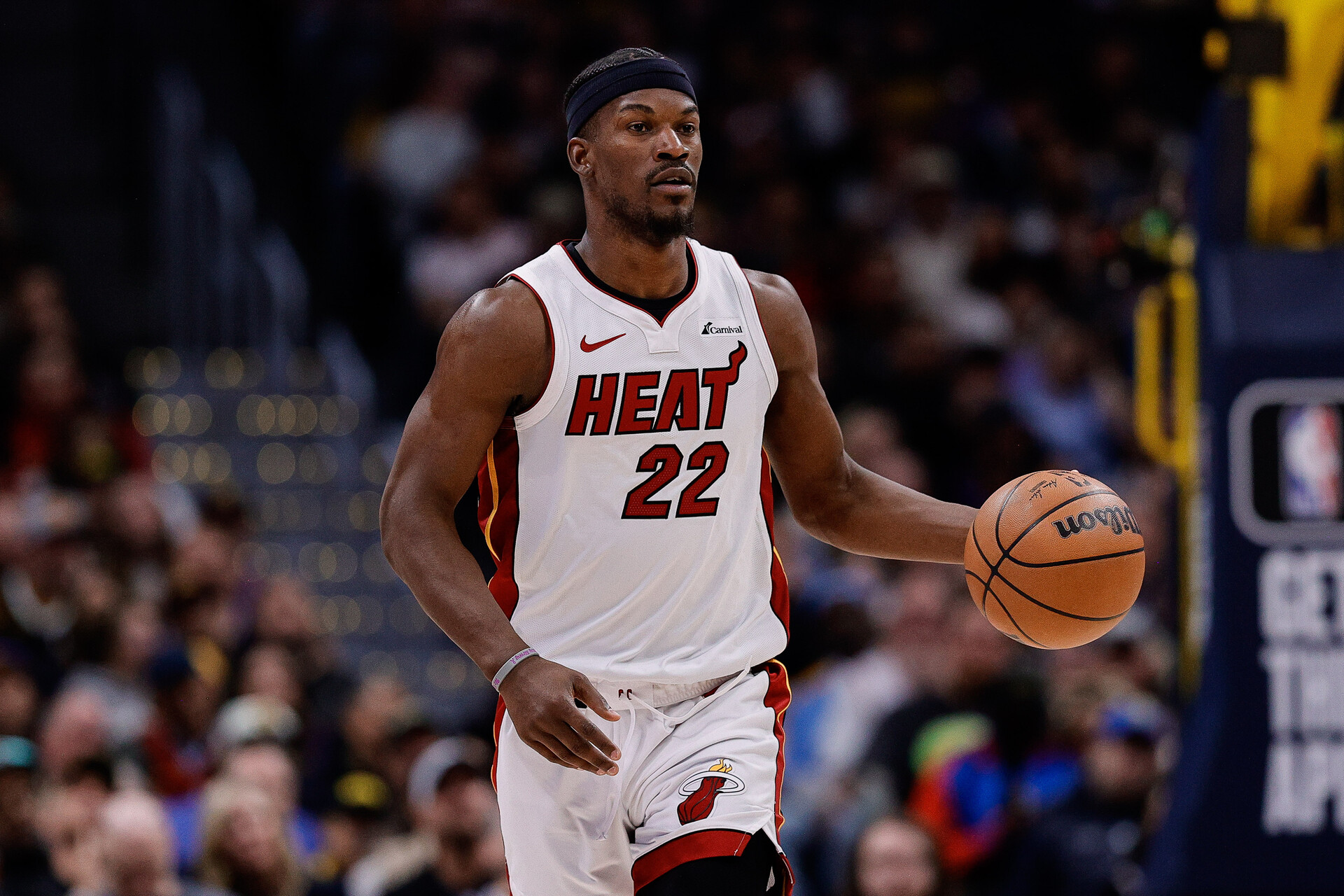 Miami Heat forward Jimmy Butler (22) dribbles the ball up court in the fourth quarter against the Denver Nuggets at Ball Arena.