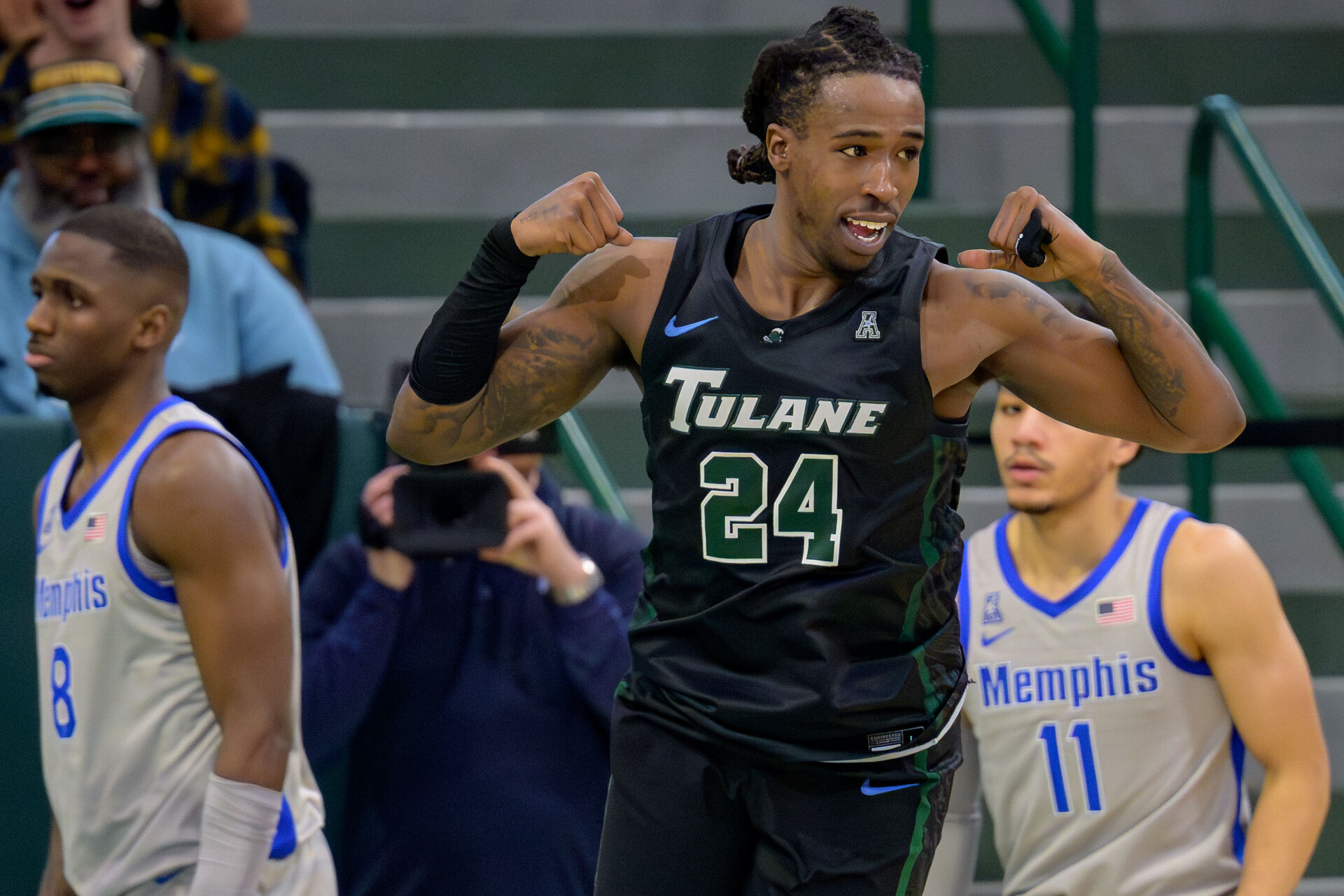 Jan 21, 2024; New Orleans, Louisiana, USA; Tulane Green Wave forward Kevin Cross (24) celebrates a score during the second half next Memphis Tigers forward David Jones (8) and guard Jahvon Quinerly (11) at Avron B. Fogelman Arena in Devlin Fieldhouse.
