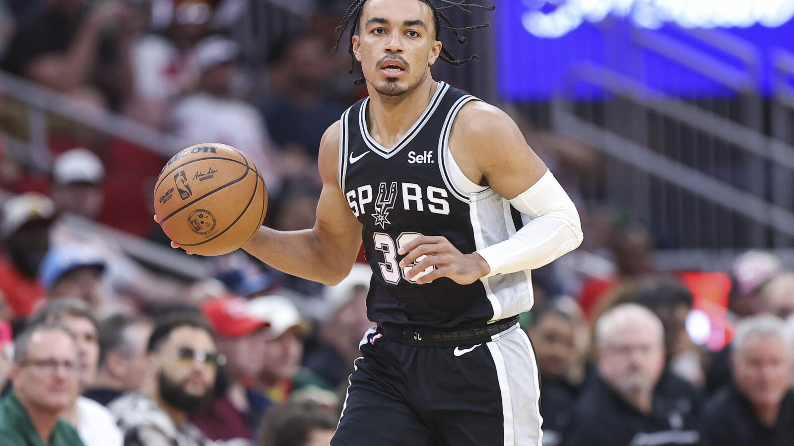 Mar 5, 2024; Houston, Texas, USA; San Antonio Spurs guard Tre Jones (33) dribbles the ball during the first quarter against the Houston Rockets at Toyota Center.