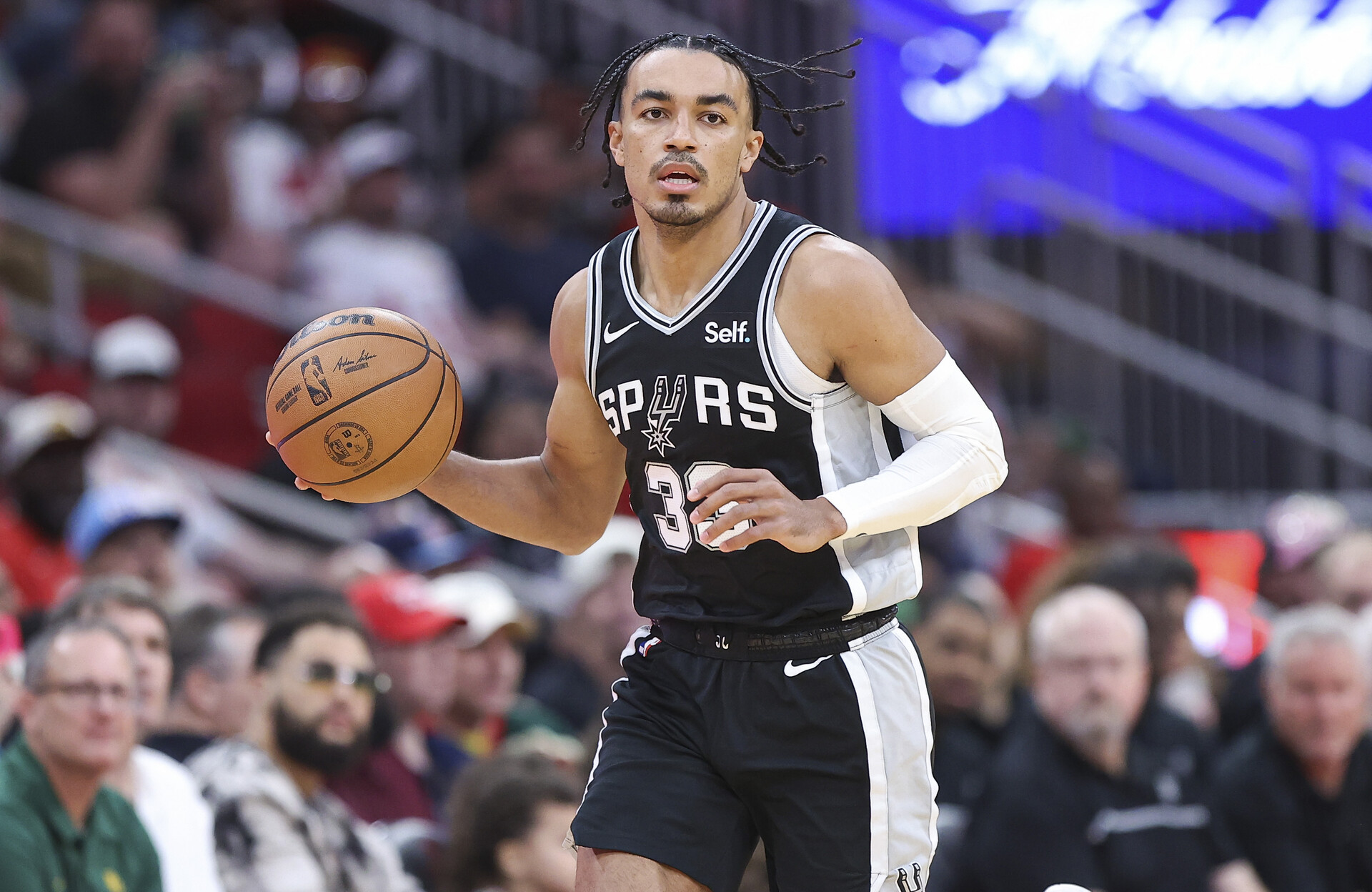 Mar 5, 2024; Houston, Texas, USA; San Antonio Spurs guard Tre Jones (33) dribbles the ball during the first quarter against the Houston Rockets at Toyota Center.