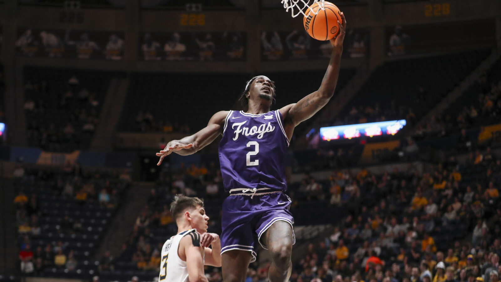 Mar 6, 2024; Morgantown, West Virginia, USA; TCU Horned Frogs forward Emanuel Miller (2) shoots in the lane during the first half against the West Virginia Mountaineers at WVU Coliseum.