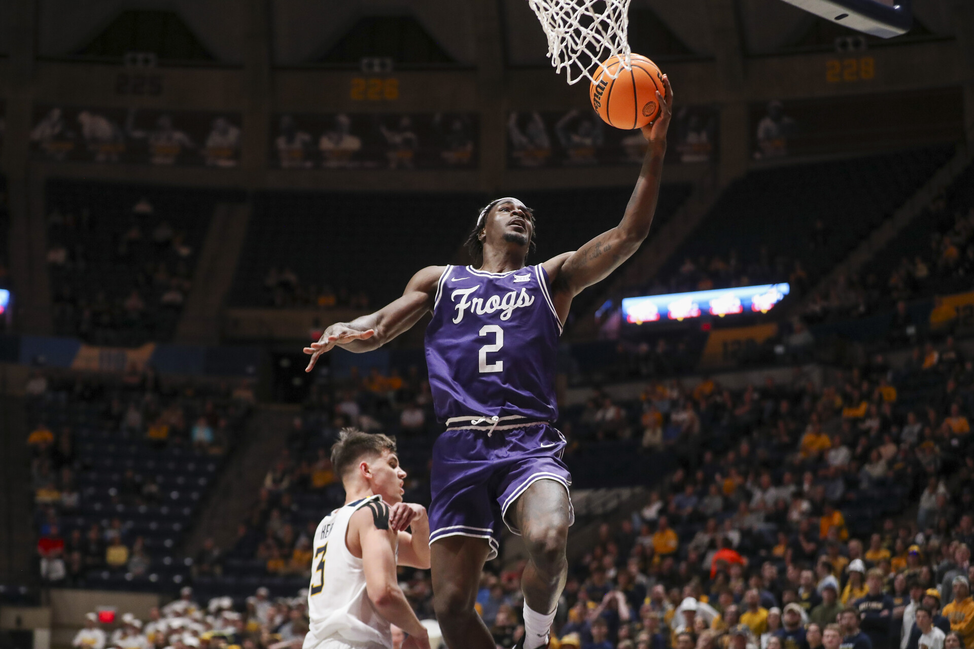 Mar 6, 2024; Morgantown, West Virginia, USA; TCU Horned Frogs forward Emanuel Miller (2) shoots in the lane during the first half against the West Virginia Mountaineers at WVU Coliseum.