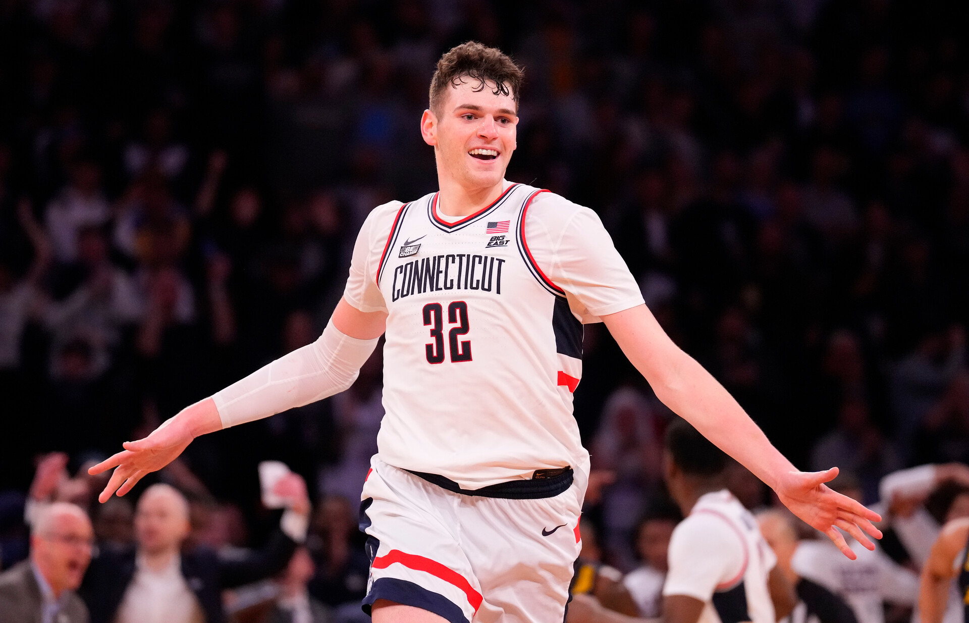 Mar 16, 2024; New York City, NY, USA; Connecticut Huskies center Donovan Clingan (32) celebrates as the clock winds down on Marquette Golden Eagles in the second half at Madison Square Garden.