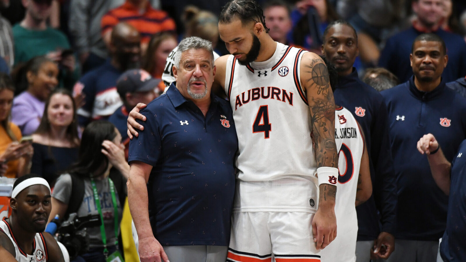 Mar 17, 2024; Nashville, TN, USA; Auburn Tigers forward Johni Broome (4) embraces head coach Bruce Pearl in the second half against the Florida Gators in the SEC Tournament championship game at Bridgestone Arena.