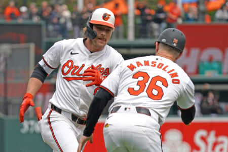 Baltimore Orioles shortstop Gunnar Henderson (2) greeted by coach Tony Mansolino (36) following his solo home run in the first inning against the Minnesota Twins at Oriole Park at Camden Yards.