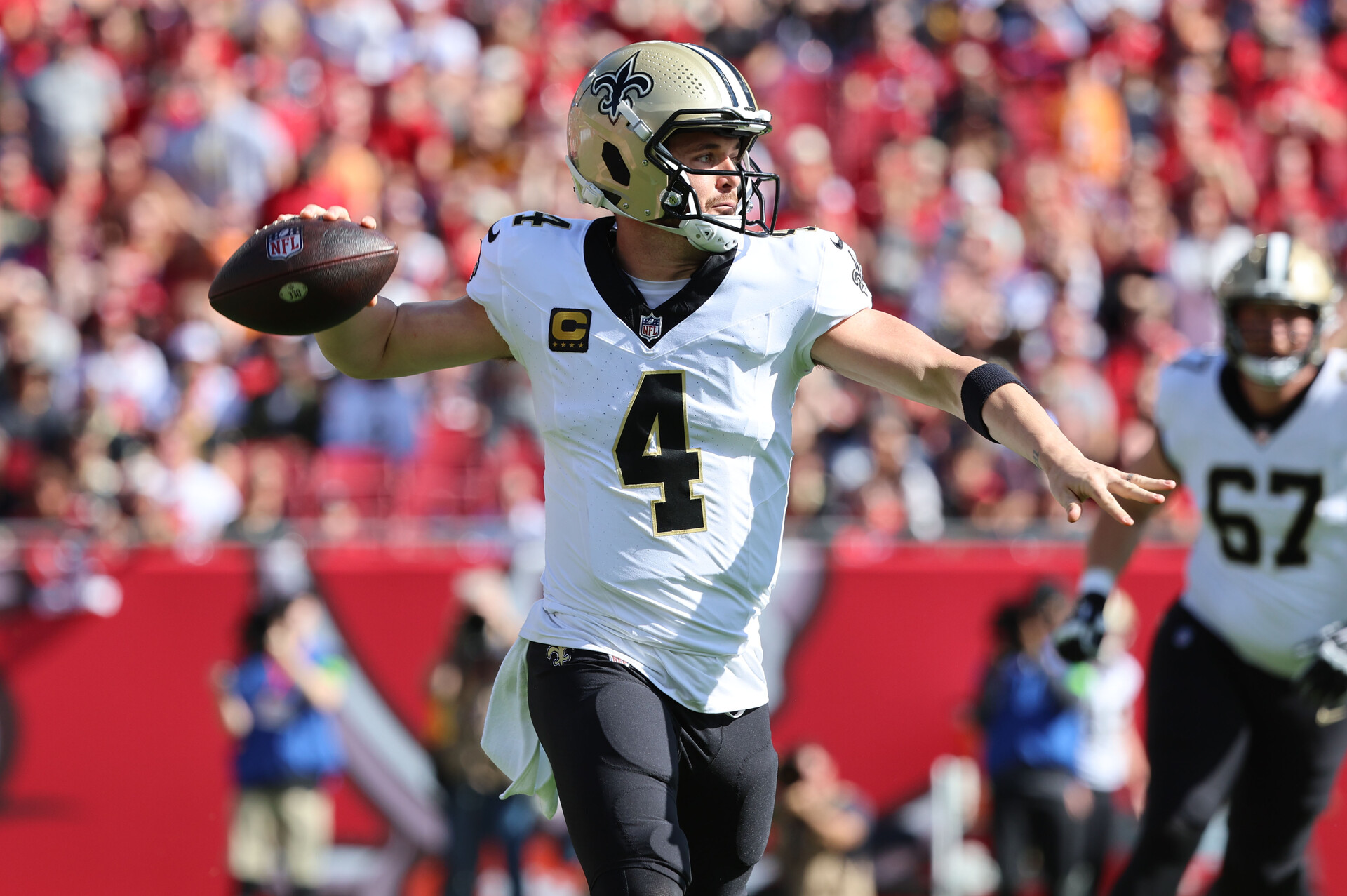 Dec 31, 2023; Tampa, Florida, USA; New Orleans Saints quarterback Derek Carr (4) throws the ball against the Tampa Bay Buccaneers during the first quarter at Raymond James Stadium.